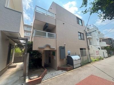 三階建ての住宅の外観と通りの風景