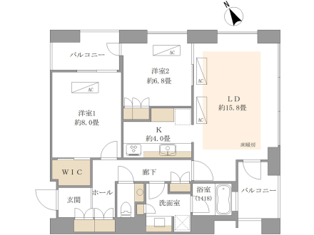 家具と部屋のレイアウトを示した間取り図。二つのバルコニー、二つの洋室、リビングダイニング、キッチン、浴室、洗面所、トイレ、ウォークインクローゼット、玄関、廊下、ホールが描かれている。