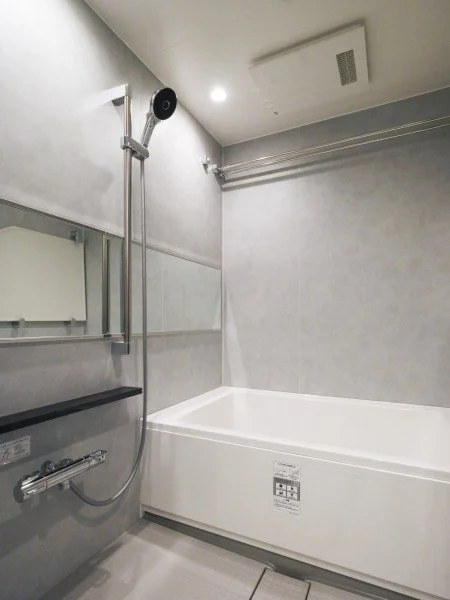 浴室のバスタブ、シャワー、鏡と洗面台が設置された清潔なバスルームの interior.