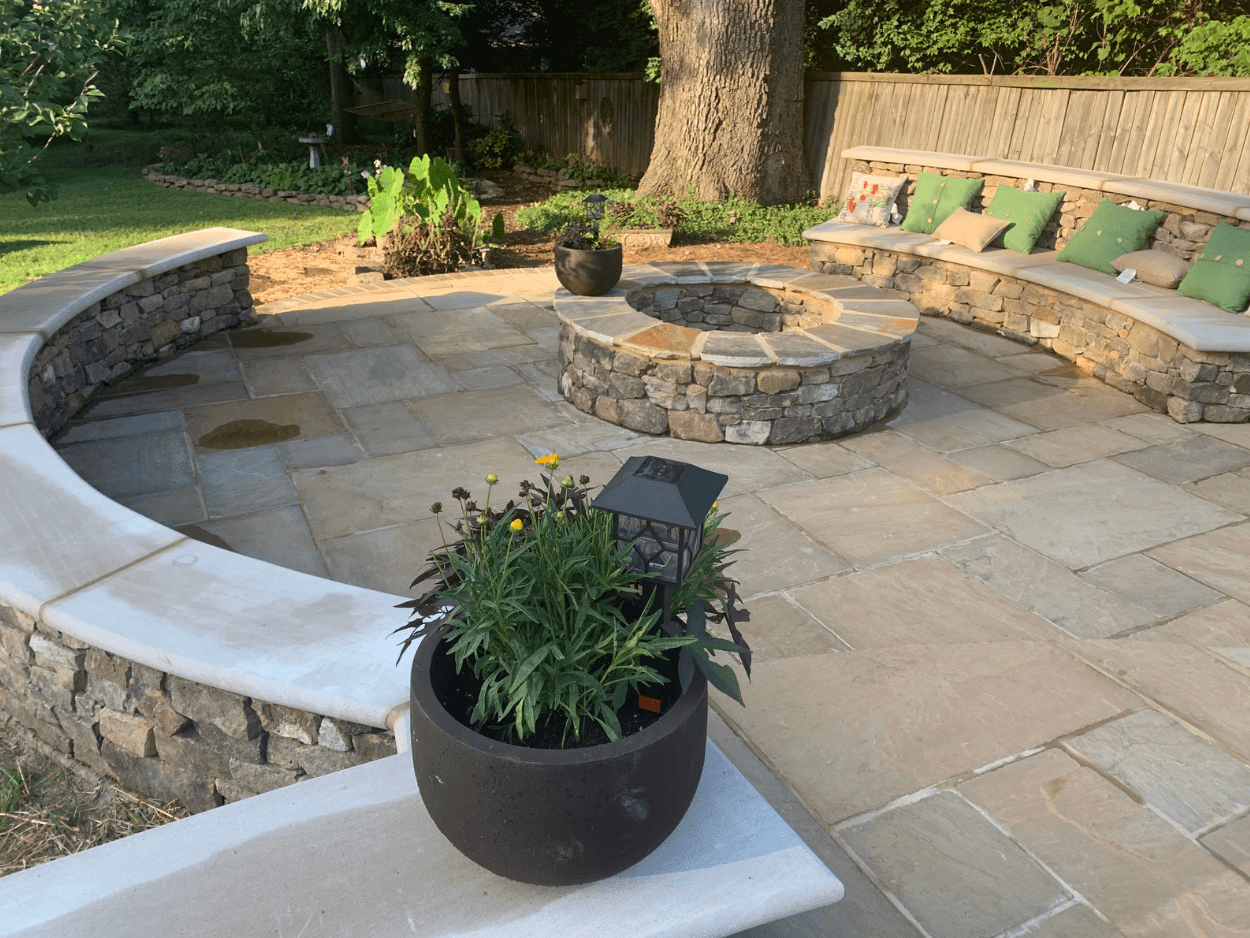 Custom stone patio hardscaping with decorative planters by Top Turf outdoor living experts in Boise Idaho