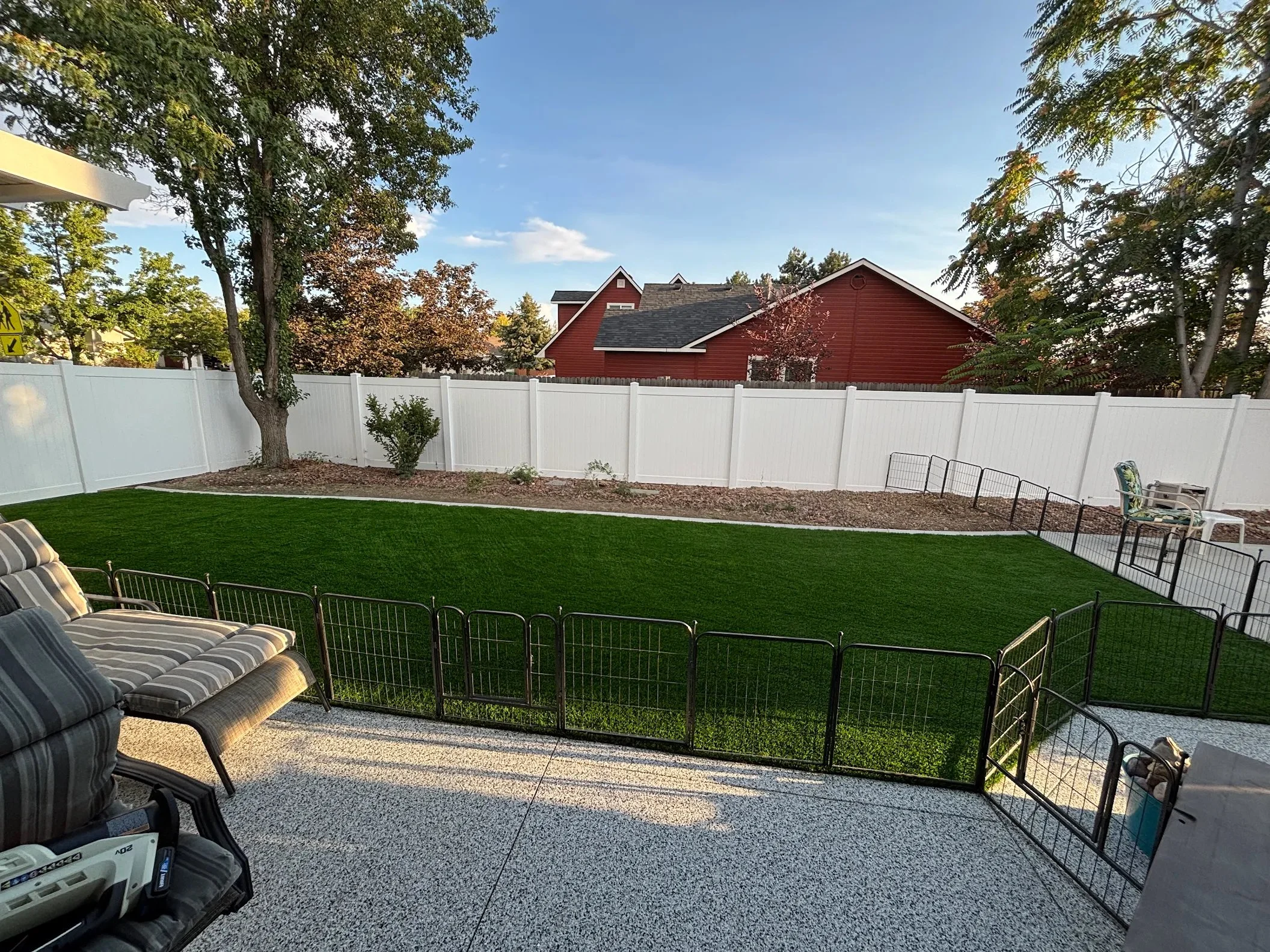 Top Turf residential artificial turf and hardscape installation with fire pit seating area in Boise Idaho