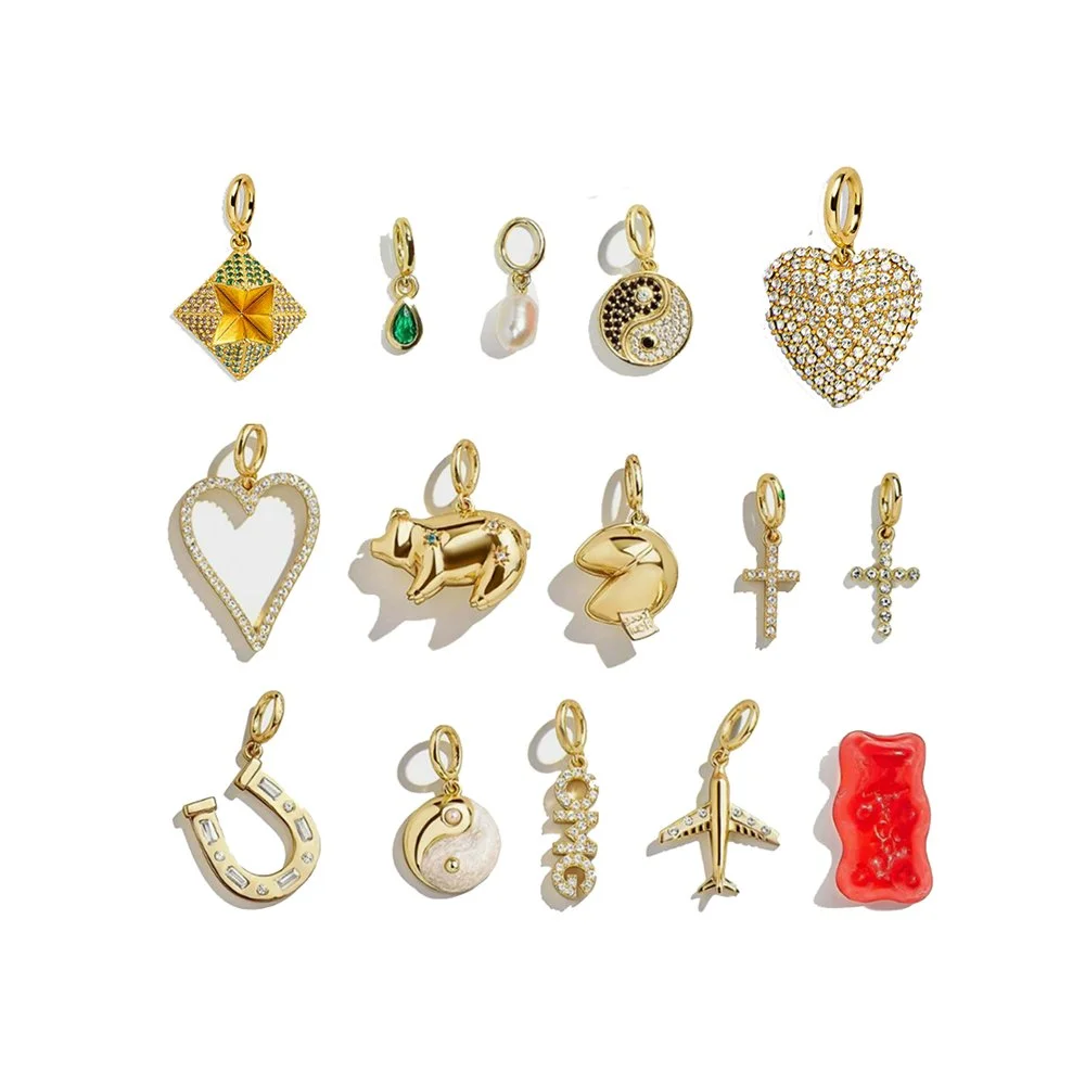 Collection of 15 gold and gemstone charms with various symbols and designs.