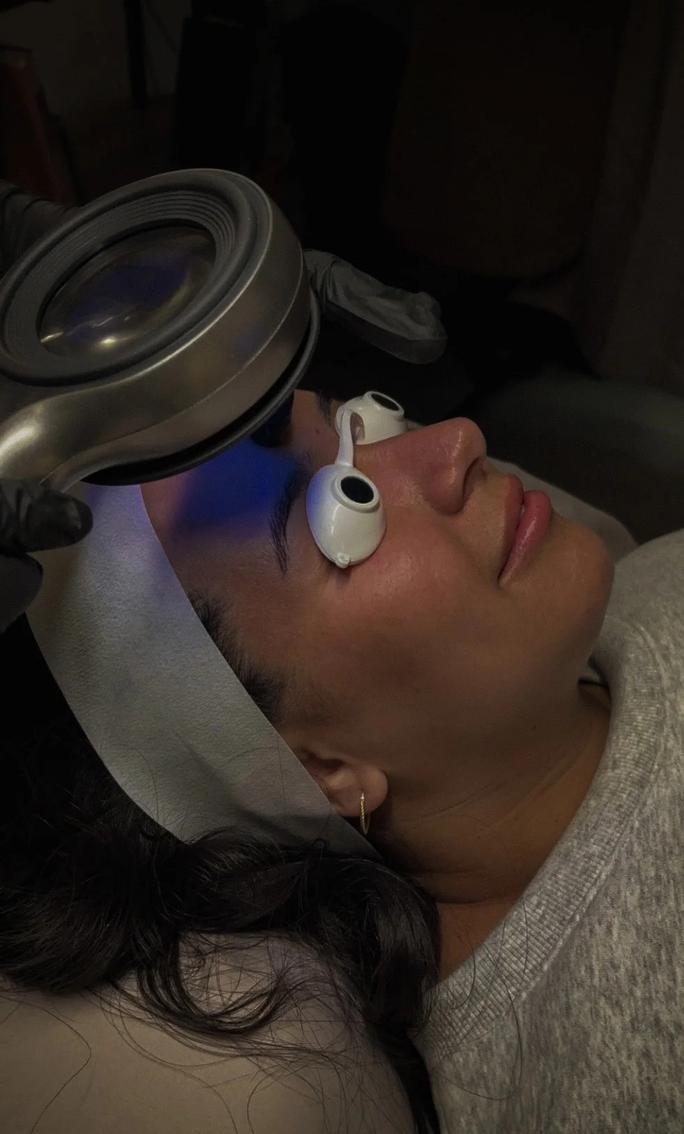 Client receiving an advanced facial treatment with protective eyewear at Éclat & Co. in Omaha 