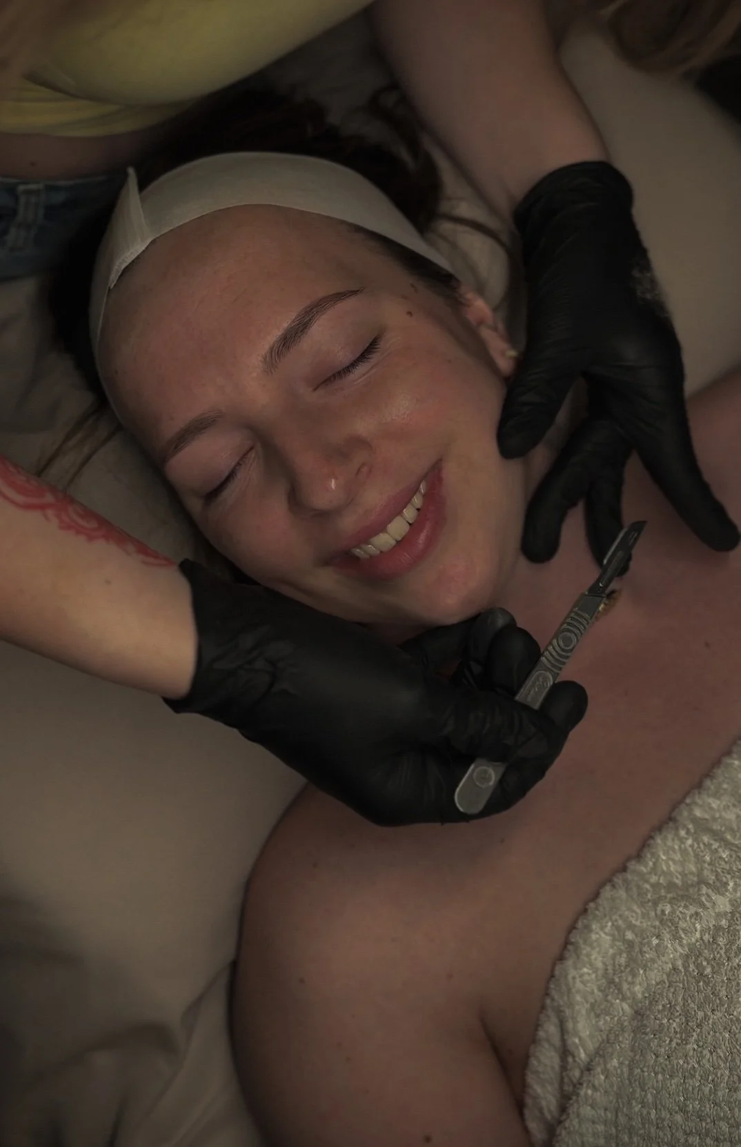 Professional dermaplaning facial treatment using an advanced skincare device at Éclat & Co. in Omaha
