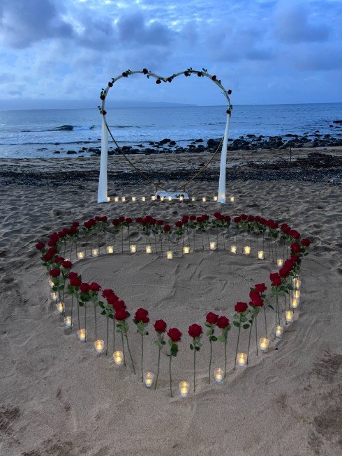 Maui beach proposal with heart-shaped roses at sunset
Romantic vow renewal setup on the beach in Maui