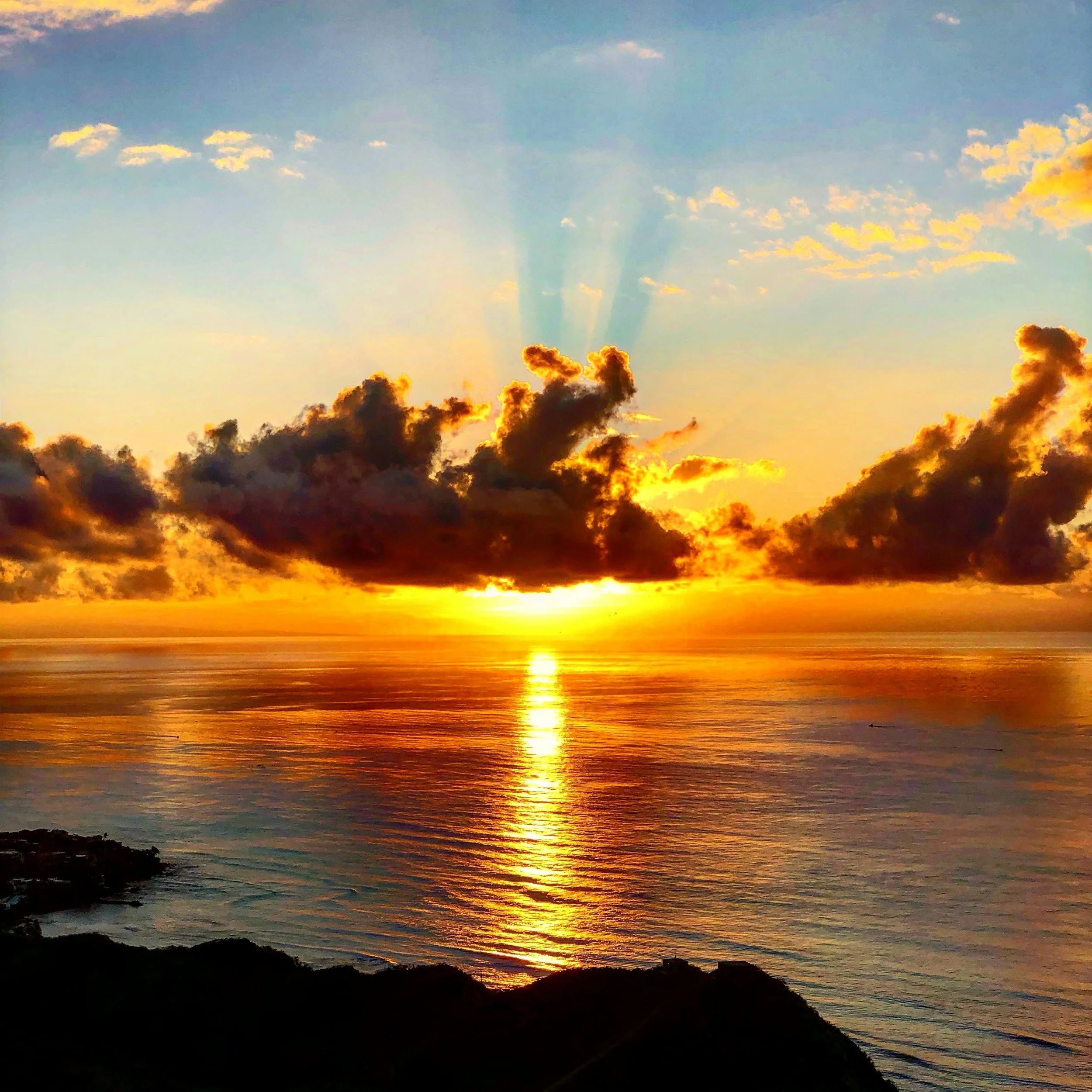 Sunset reflecting on the ocean.  rays shining above