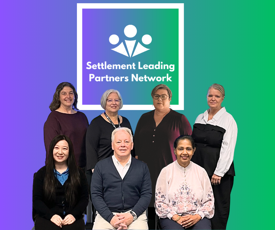 Group photo of seven diverse professionals in front of a colorful graphic background displaying a logo and text that reads 'Settlement Leading Partners Network.'