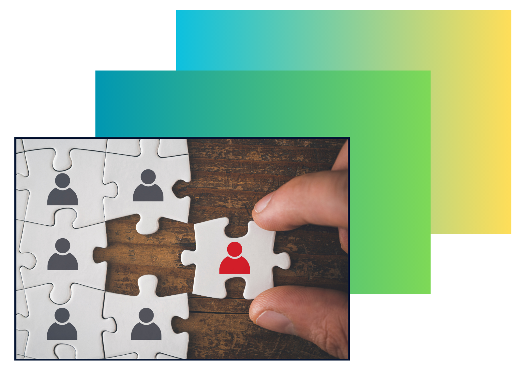 A hand placing a white puzzle piece with a red human icon into a puzzle with other black and white human icons on a wooden surface.