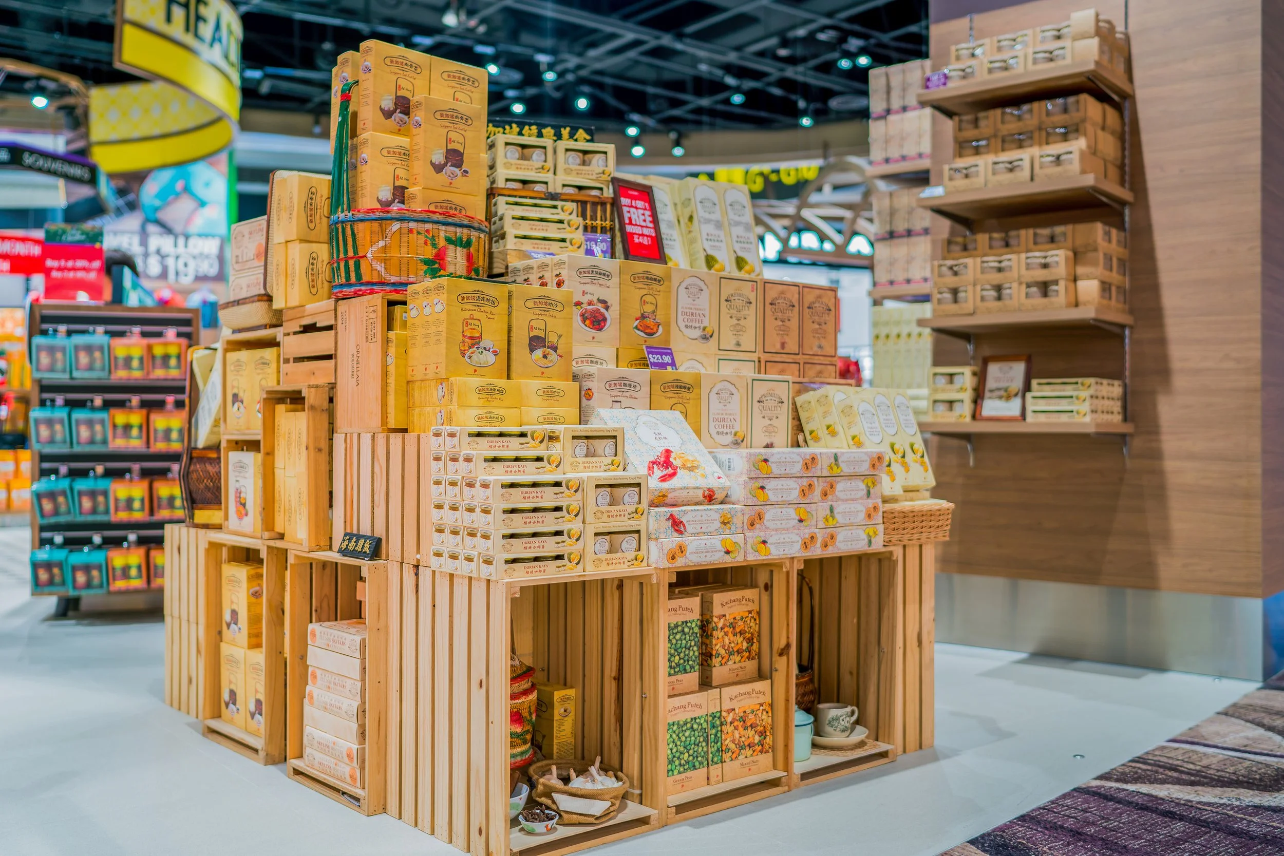 Display of packaged snacks and food products on wooden shelves in a grocery store.