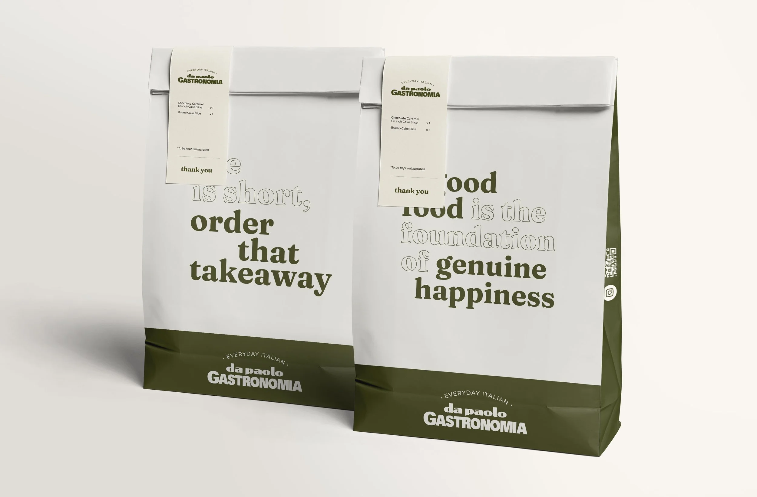 Two white takeaway food bags with green accents from da Paolo GASTRONOMIA, featuring printed text and labels for orders, placed on a white surface against a plain background.