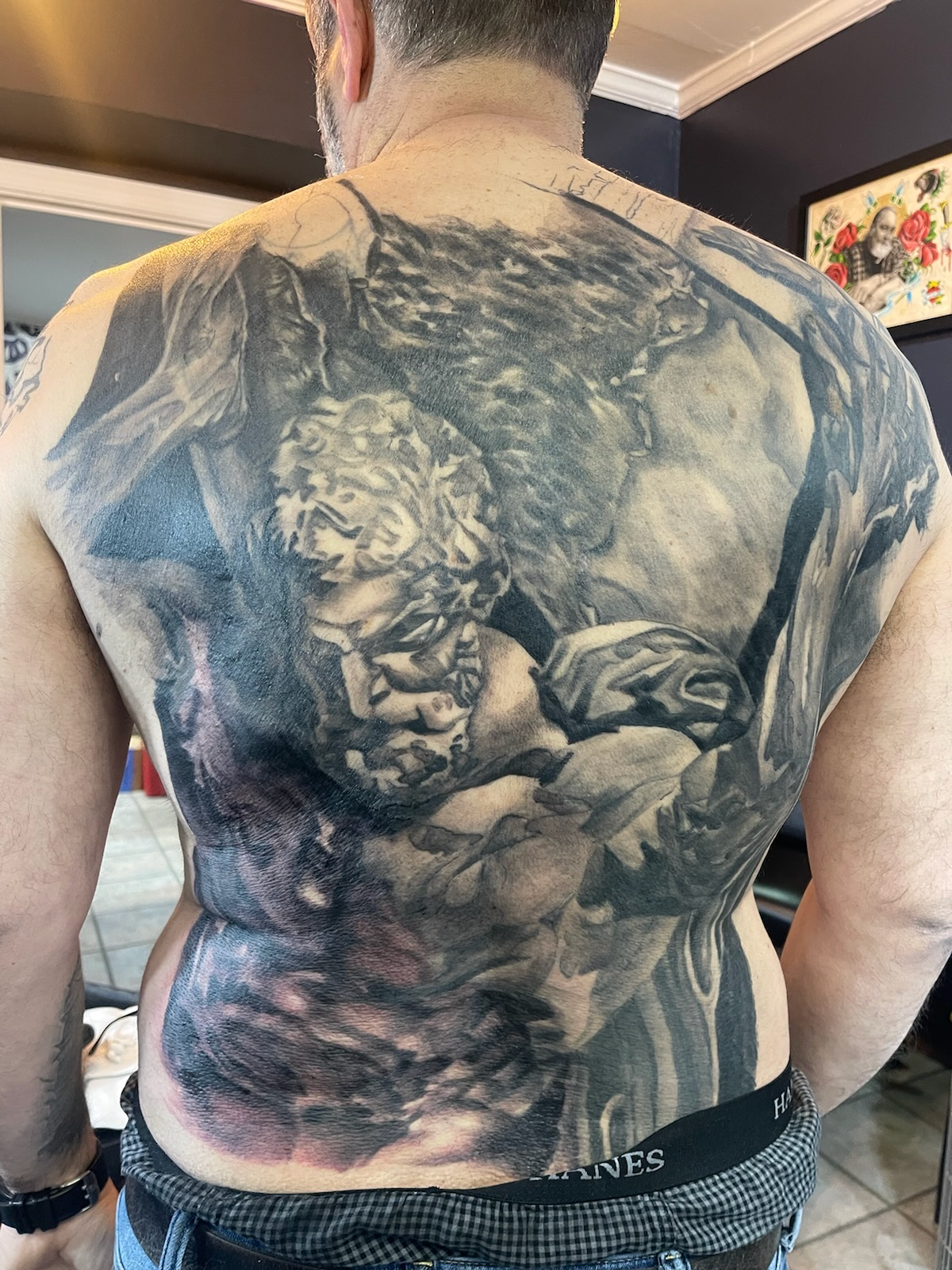 Atlas holding a boulder, full back piece in black and grey