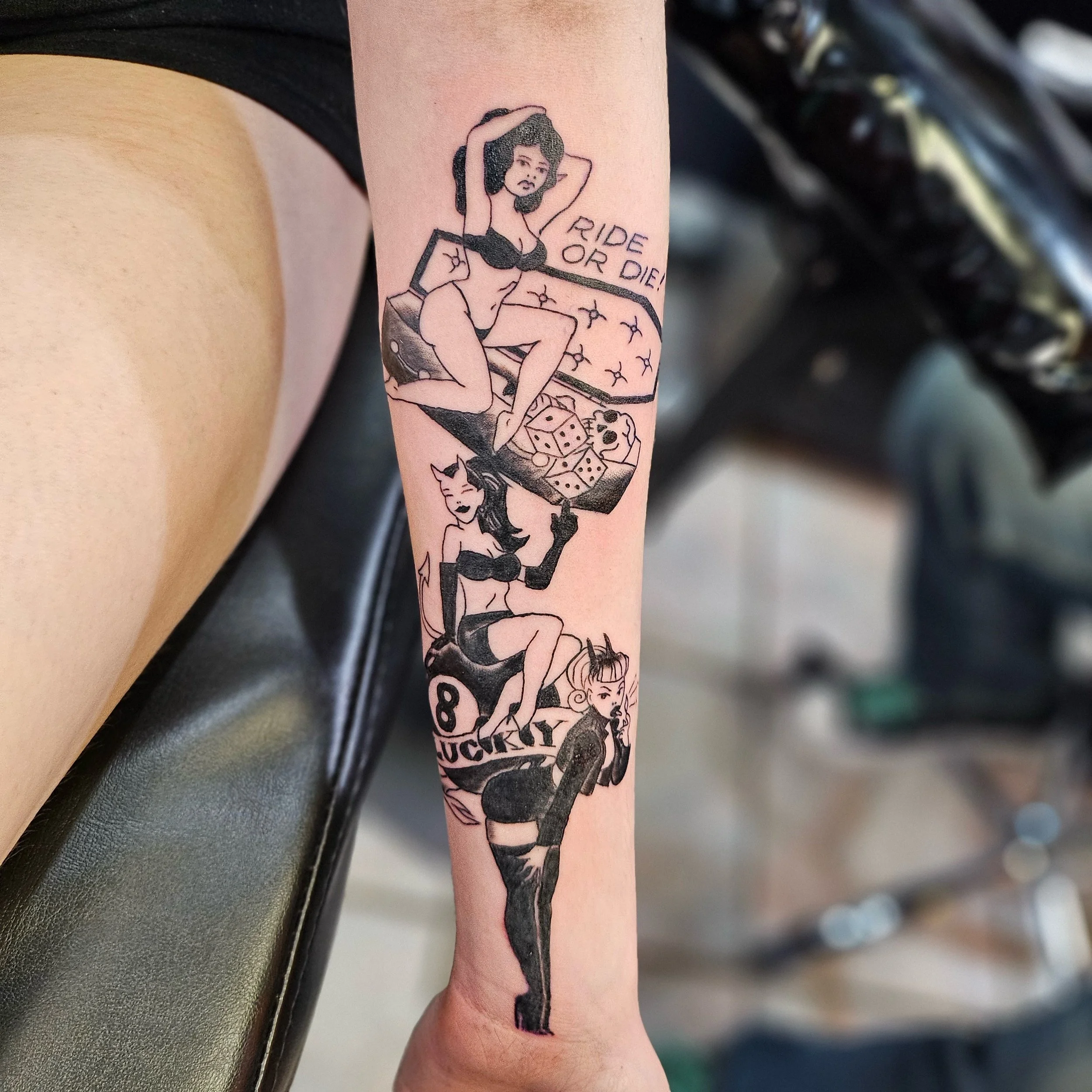Tattoo of three women with devil horns and tails, sitting on pool tables, with text "Ride or Die" and "Lucky".