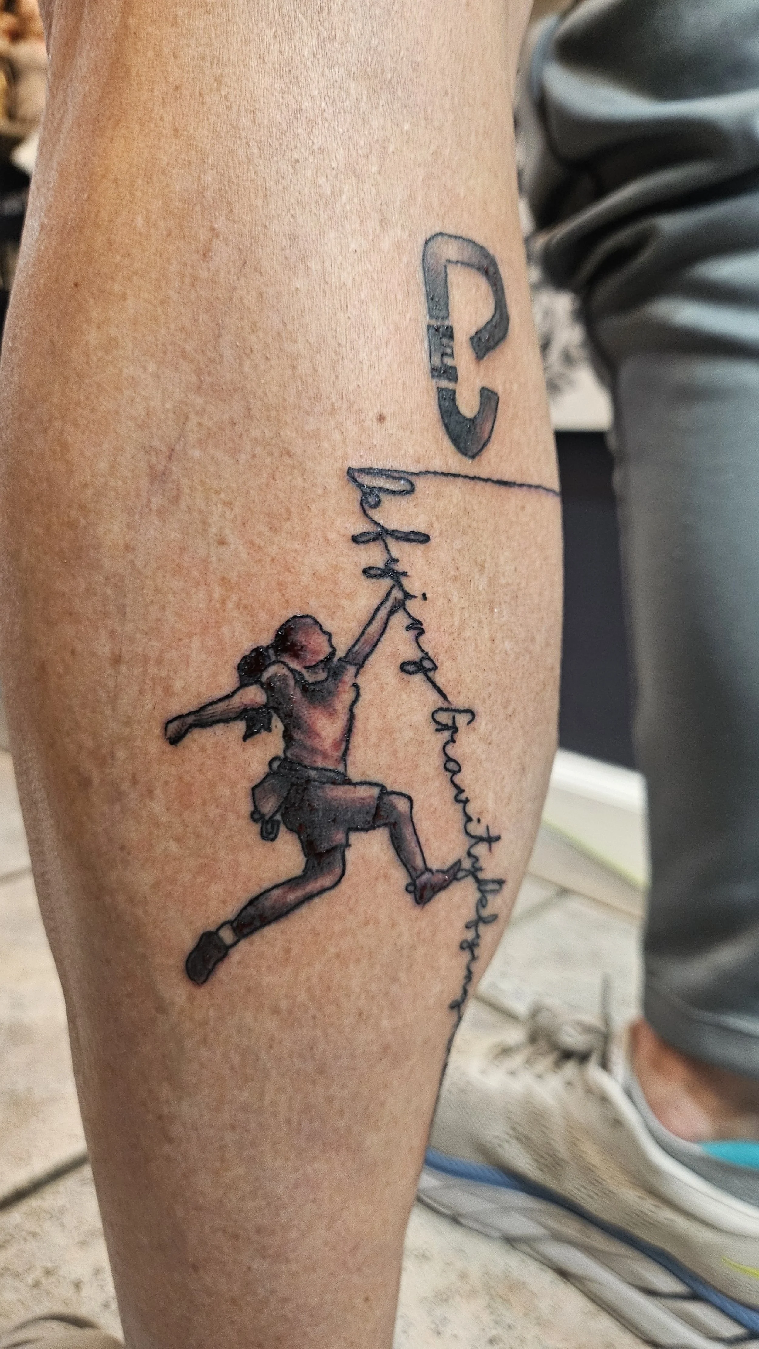 Tattoo of a girl running and holding a string connected to a balloon with the words "Life is good" written along the string.