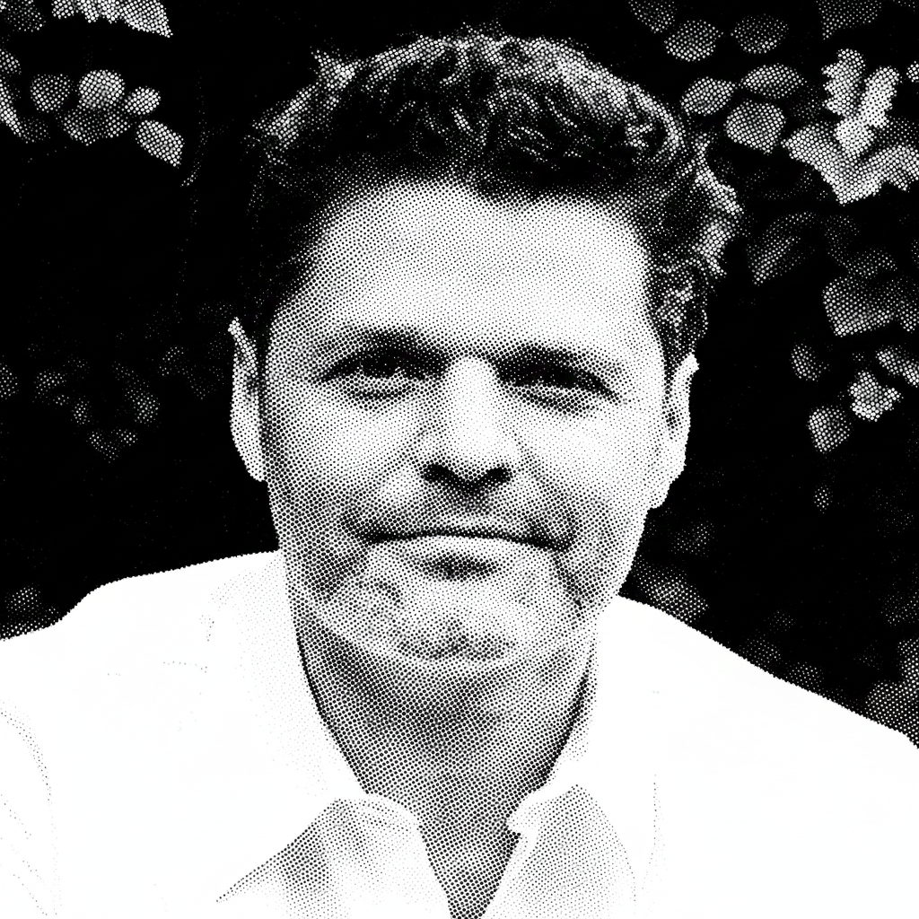 Black and white halftone portrait of a man with dark, curly hair, wearing a light-colored shirt and a bow tie, standing outdoors with foliage in the background.