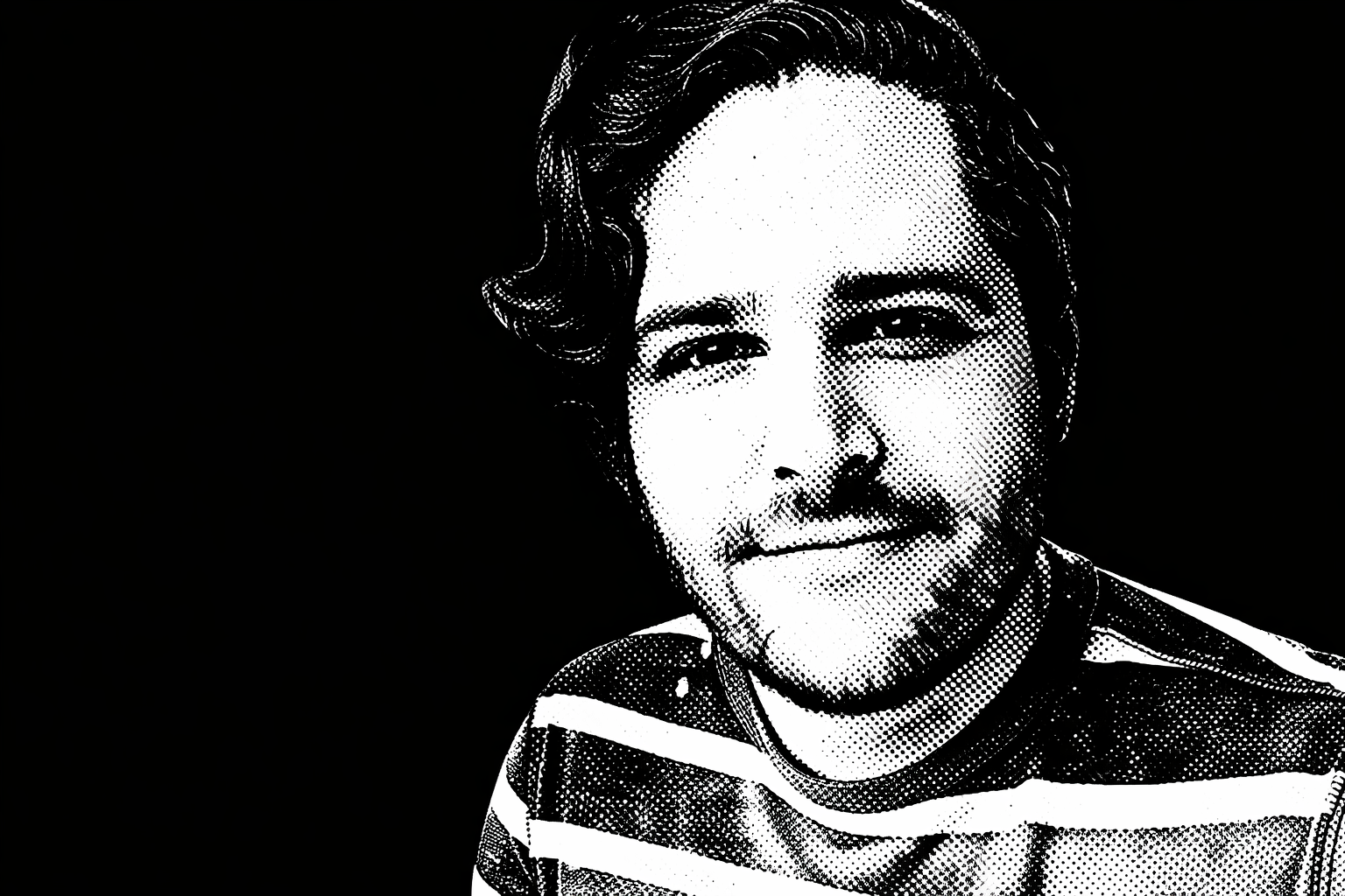 Black and white digital portrait of a smiling man with a mustache and beard, wearing a striped shirt.