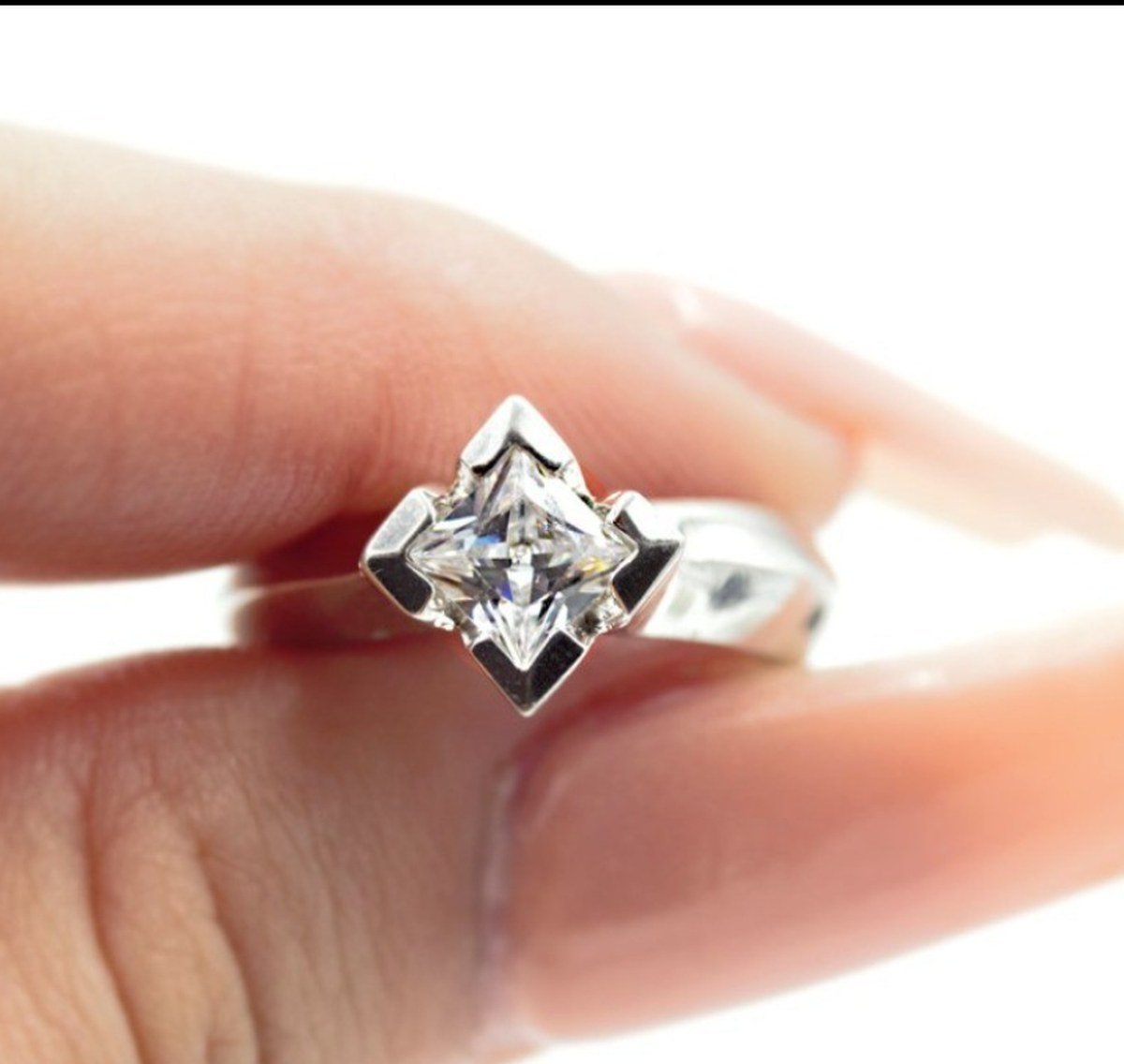 Princess-cut diamond set on point in a modern white gold engagement ring by Kaz Jewelry