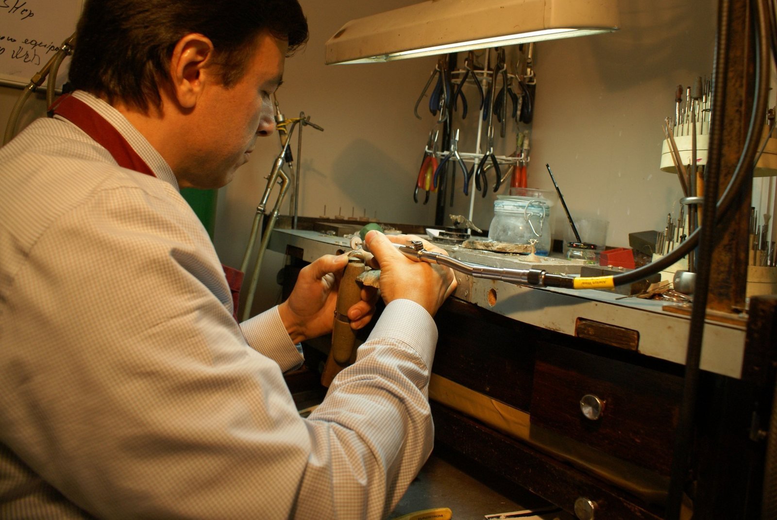 Master jeweler Albert Kaz repairing a ring at his jeweler’s bench in the Kaz Jewelry workshop