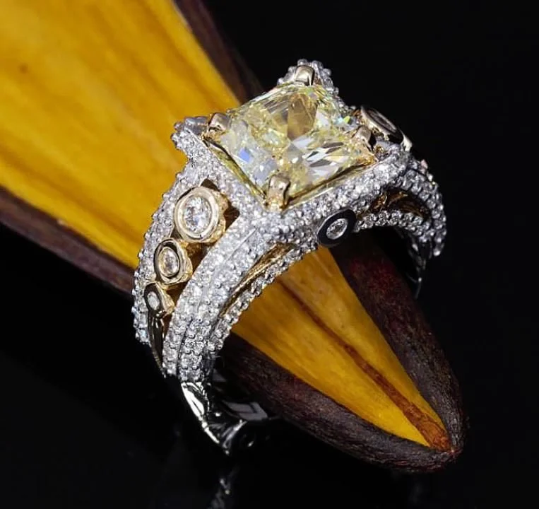 Fancy yellow diamond engagement ring with pavé band by Kaz Jewelry