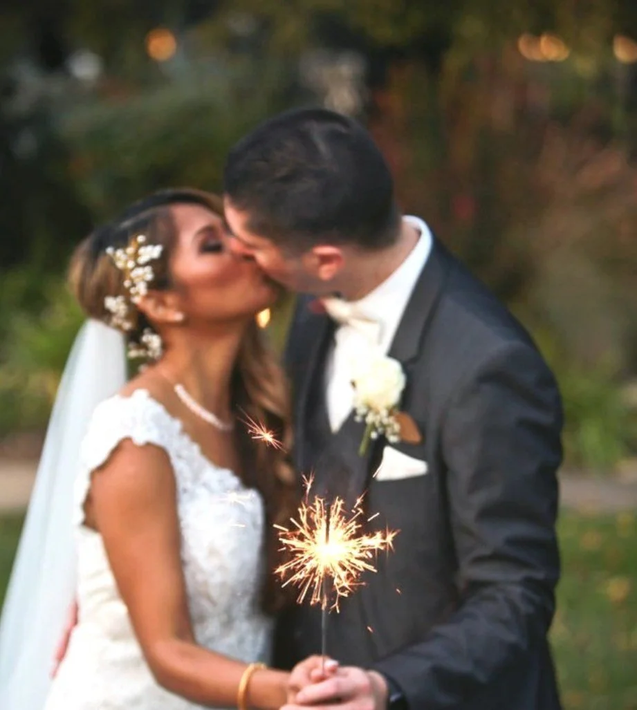 Patrick and his bride kissing on their wedding day, wearing her custom engagement ring by Kaz Jewelry