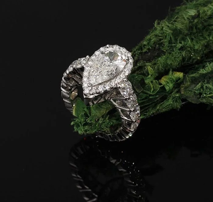 Pear-shaped diamond halo engagement ring by Kaz Jewelry