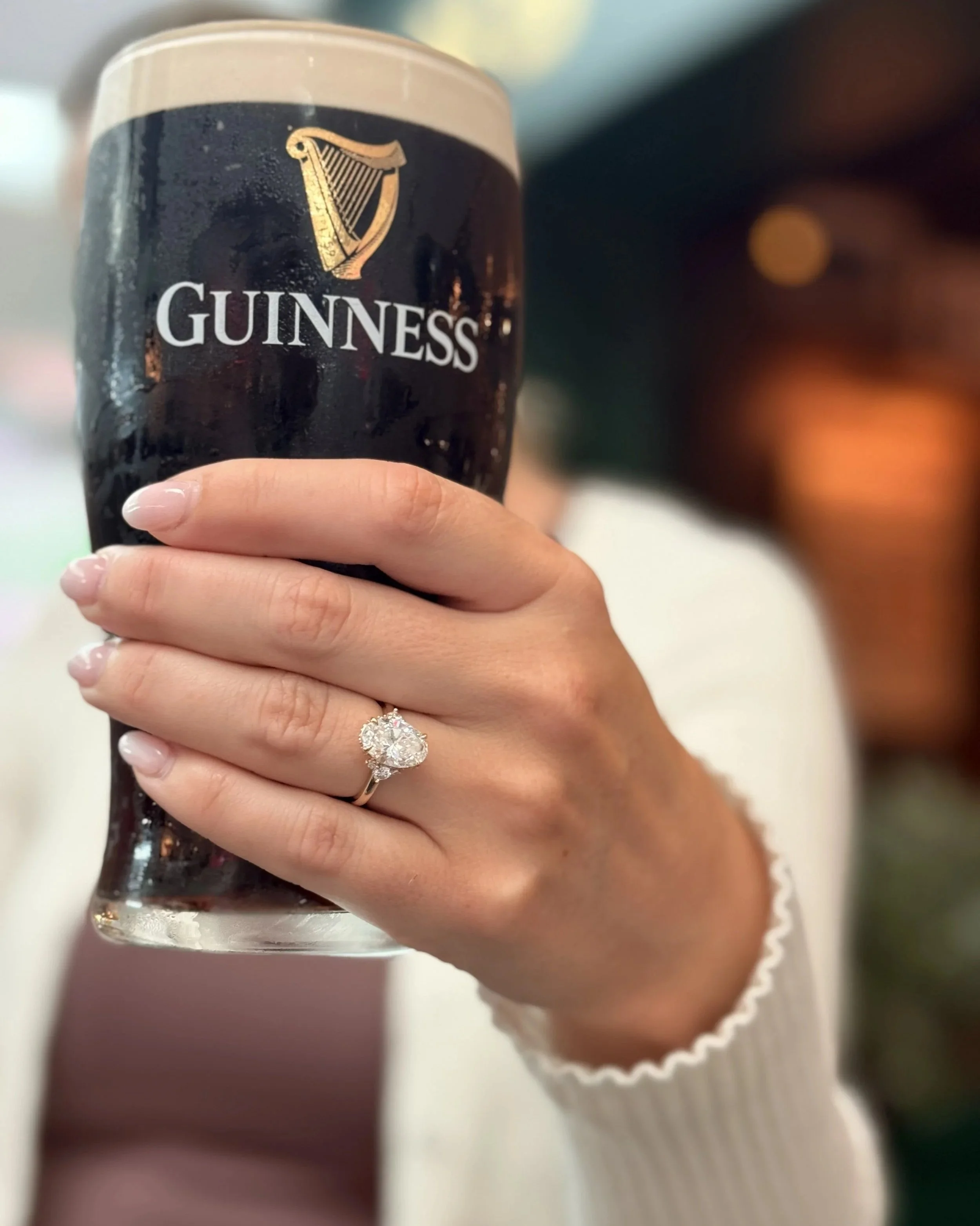 Custom oval-cut diamond engagement ring on hand, designed by Kaz Jewelry in Laguna Niguel.