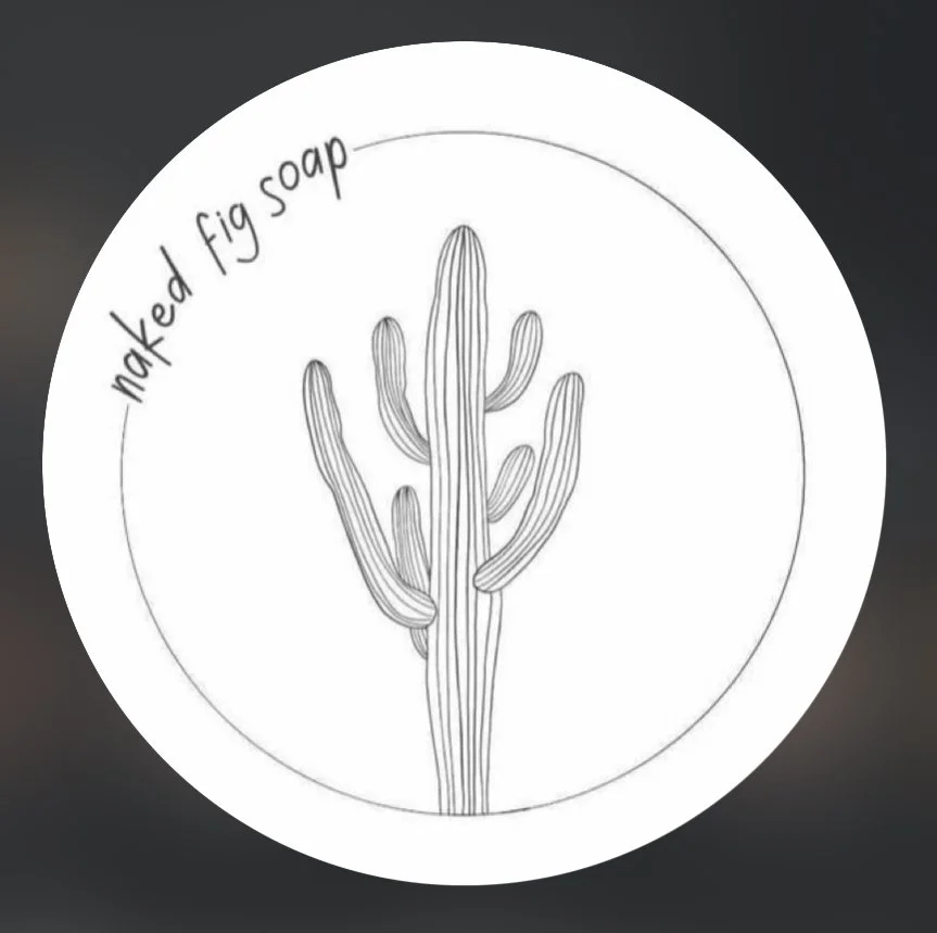 A circular logo with a line drawing of a cactus in the center. Text around the top edge reads 'naked fig soap'.