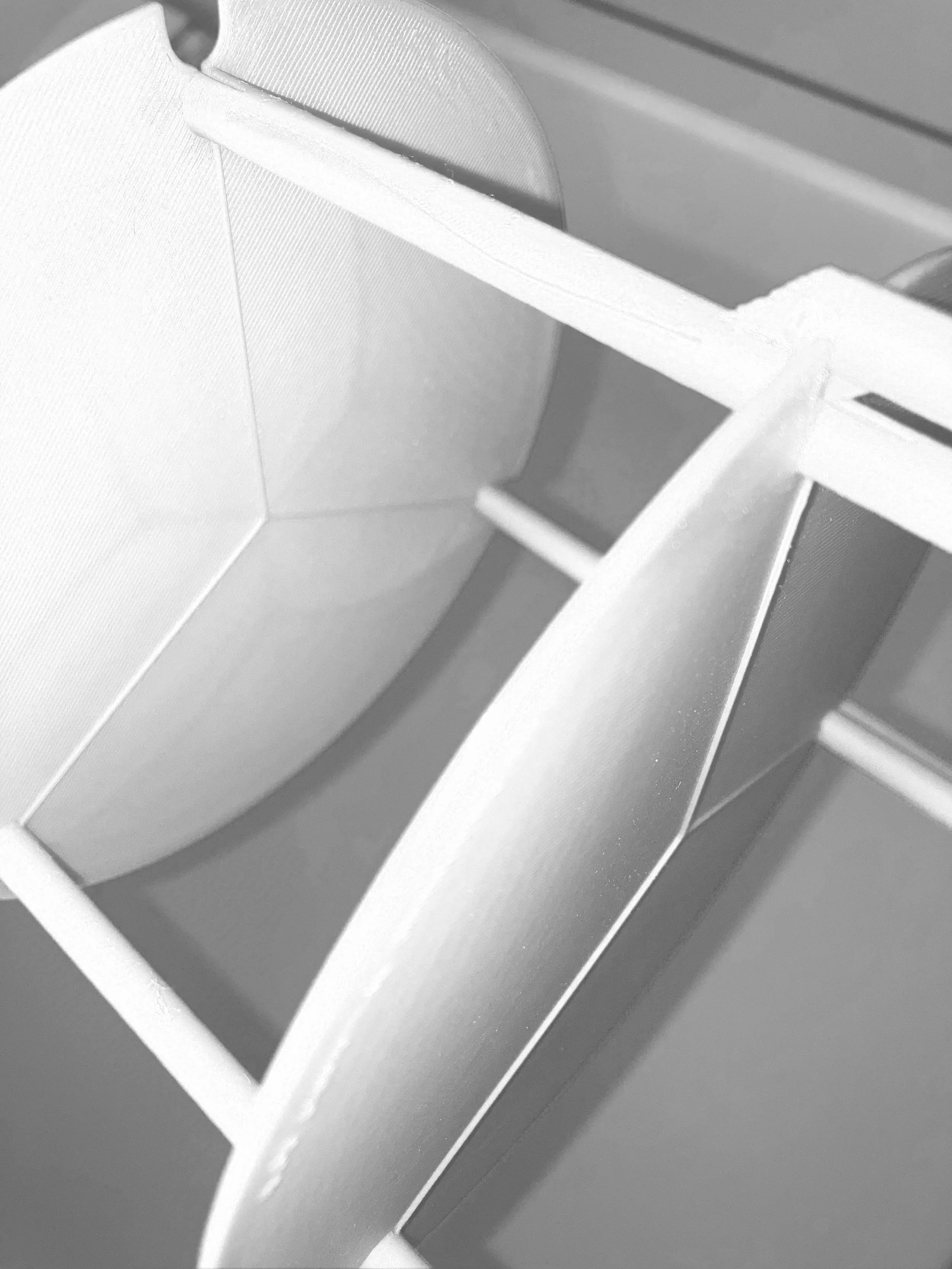 Close-up view of a small model boat in black and white.