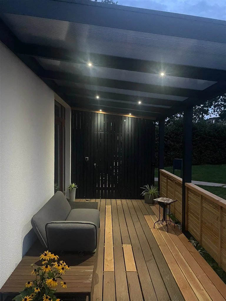 Aluminium Terrassenüberdachung mit integrierter LED Beleuchtung Abends Holzsegen