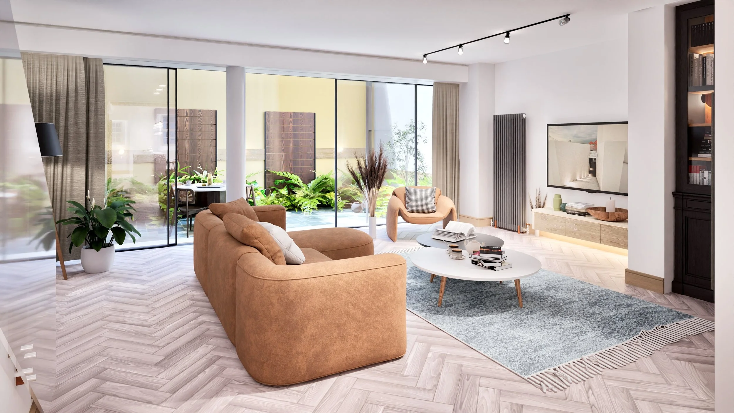 Modern living room with beige couch, white oval coffee table with books, gray rug, armchair, large windows with curtains, potted plants, wall-mounted TV, and outdoor patio with dining table and greenery.