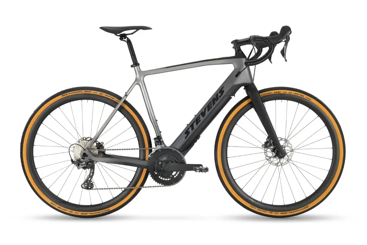A silver-grey electric bicycle with black tires, yellow tire walls and a black frame with the inscription "Stevens".
