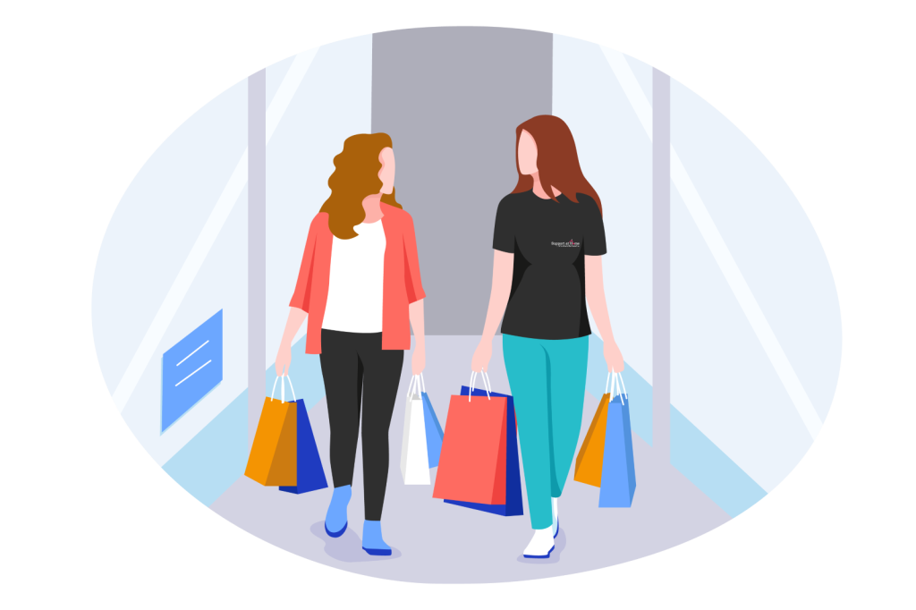 Two women walking in shopping mall elevator with shopping bags.