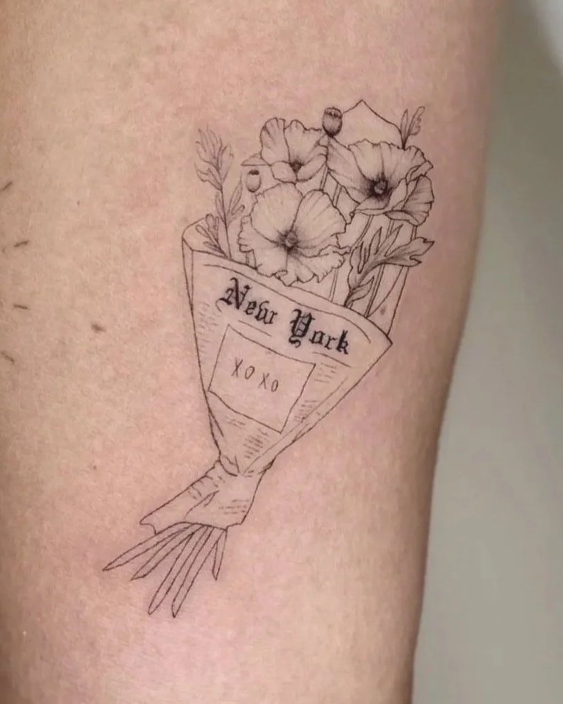 A bouquet of California poppies wrapped in New York newspaper.