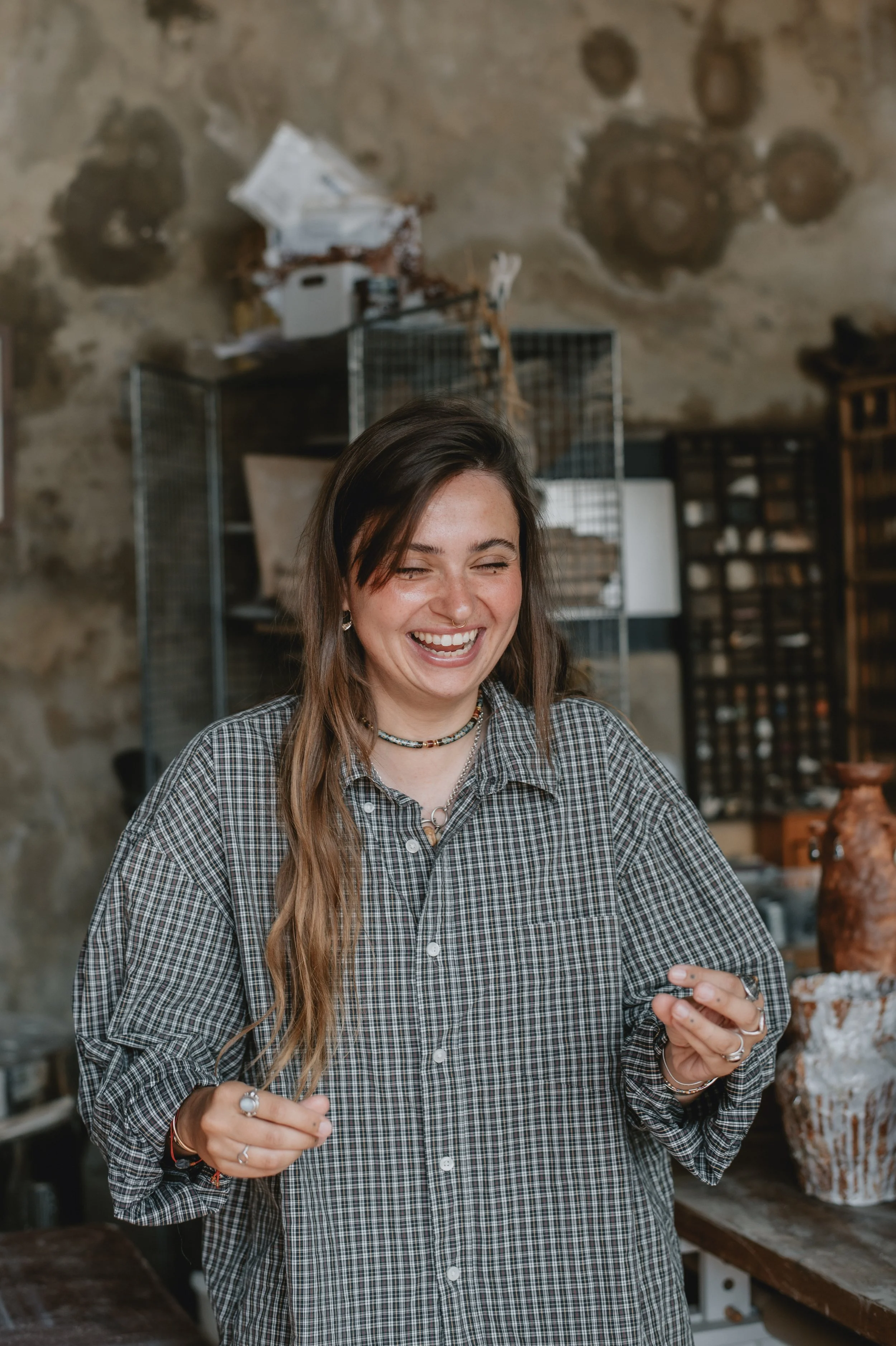 A man with dark curly hair, glasses, and a beard, looking slightly to the side with a neutral expression in a well-lit indoor setting.