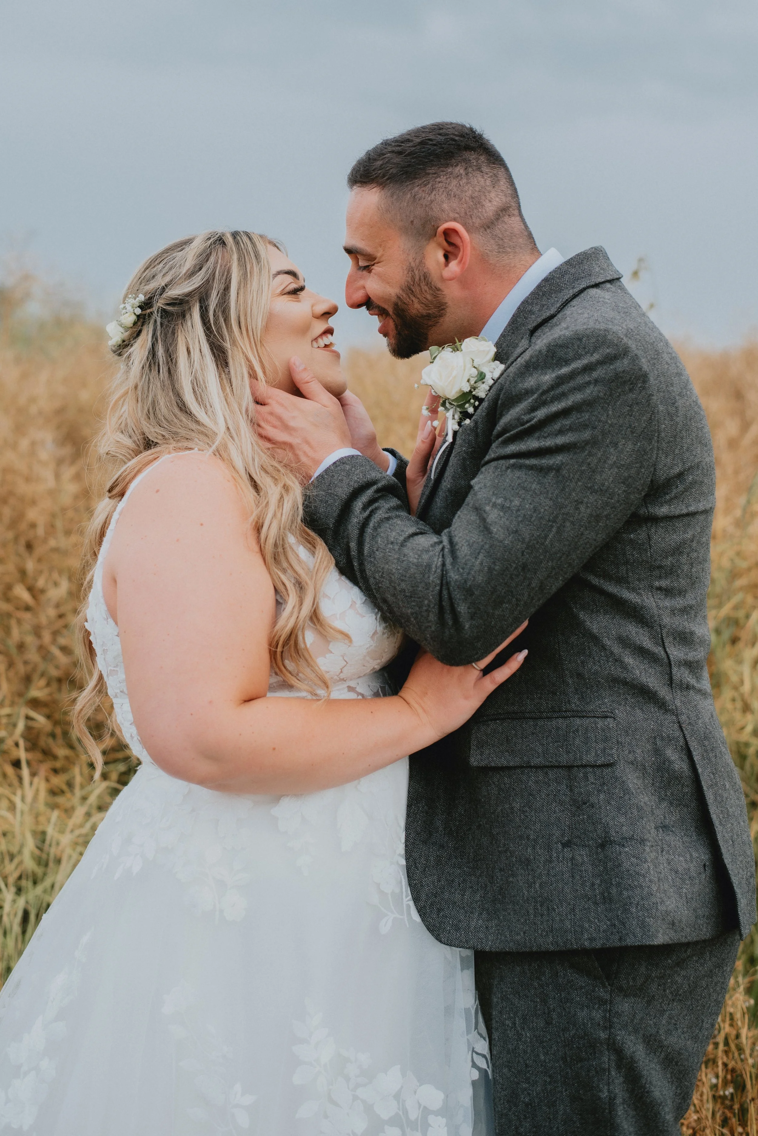 Smiling woman with shoulder-length black hair in an indoor garden with lush green plants.