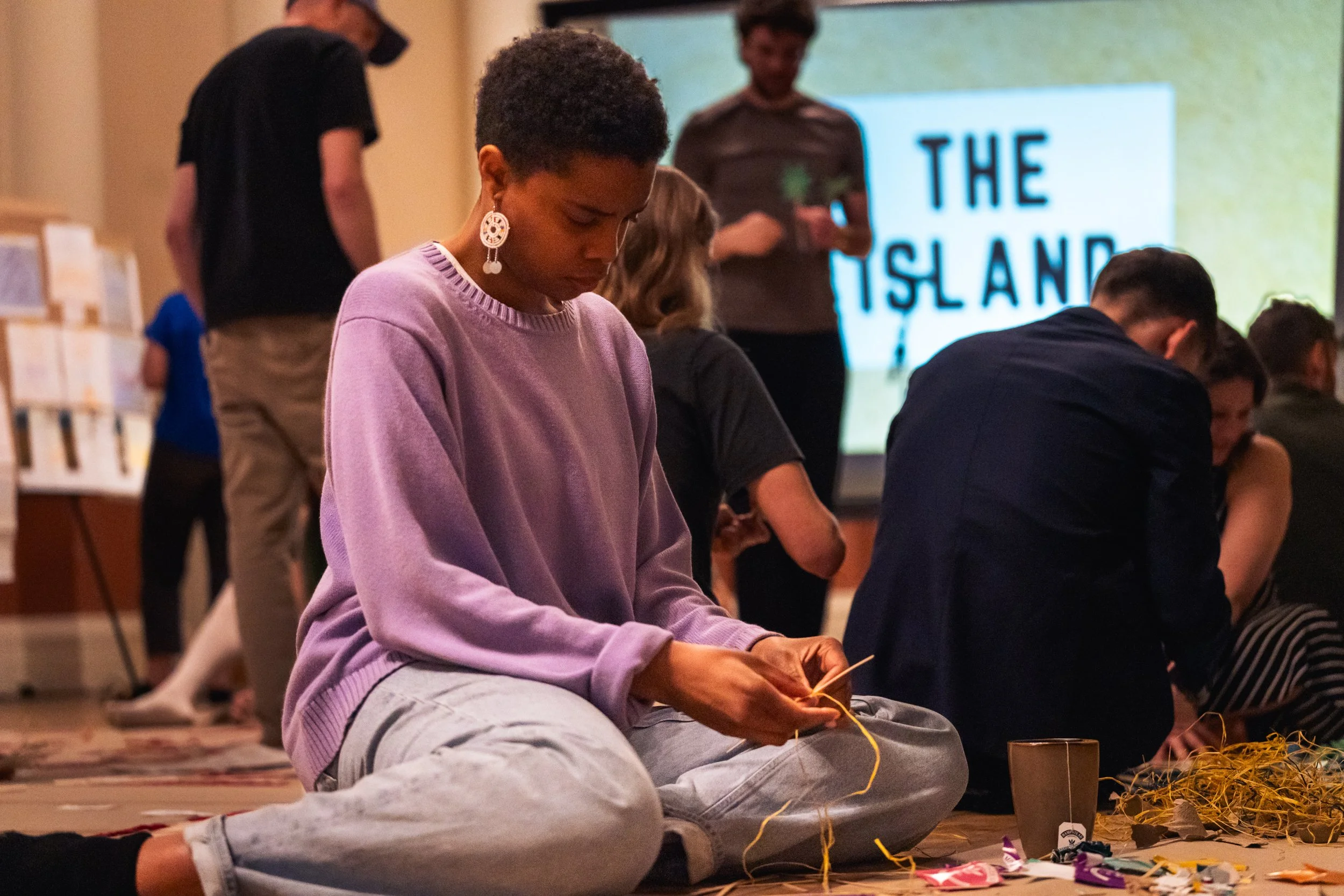 A woman makes something with her hands