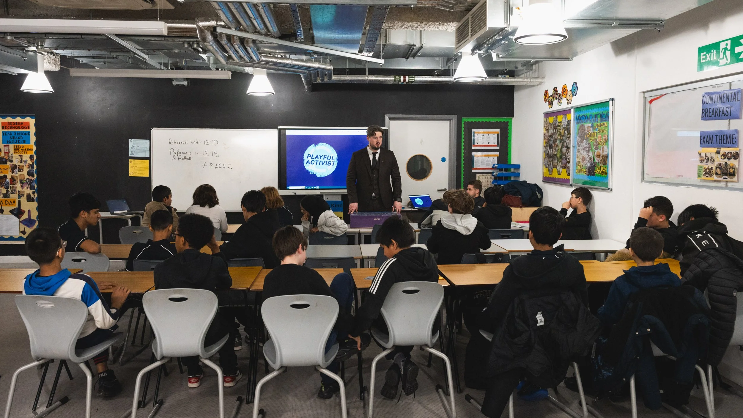 Young people in a class facing towards a teacher