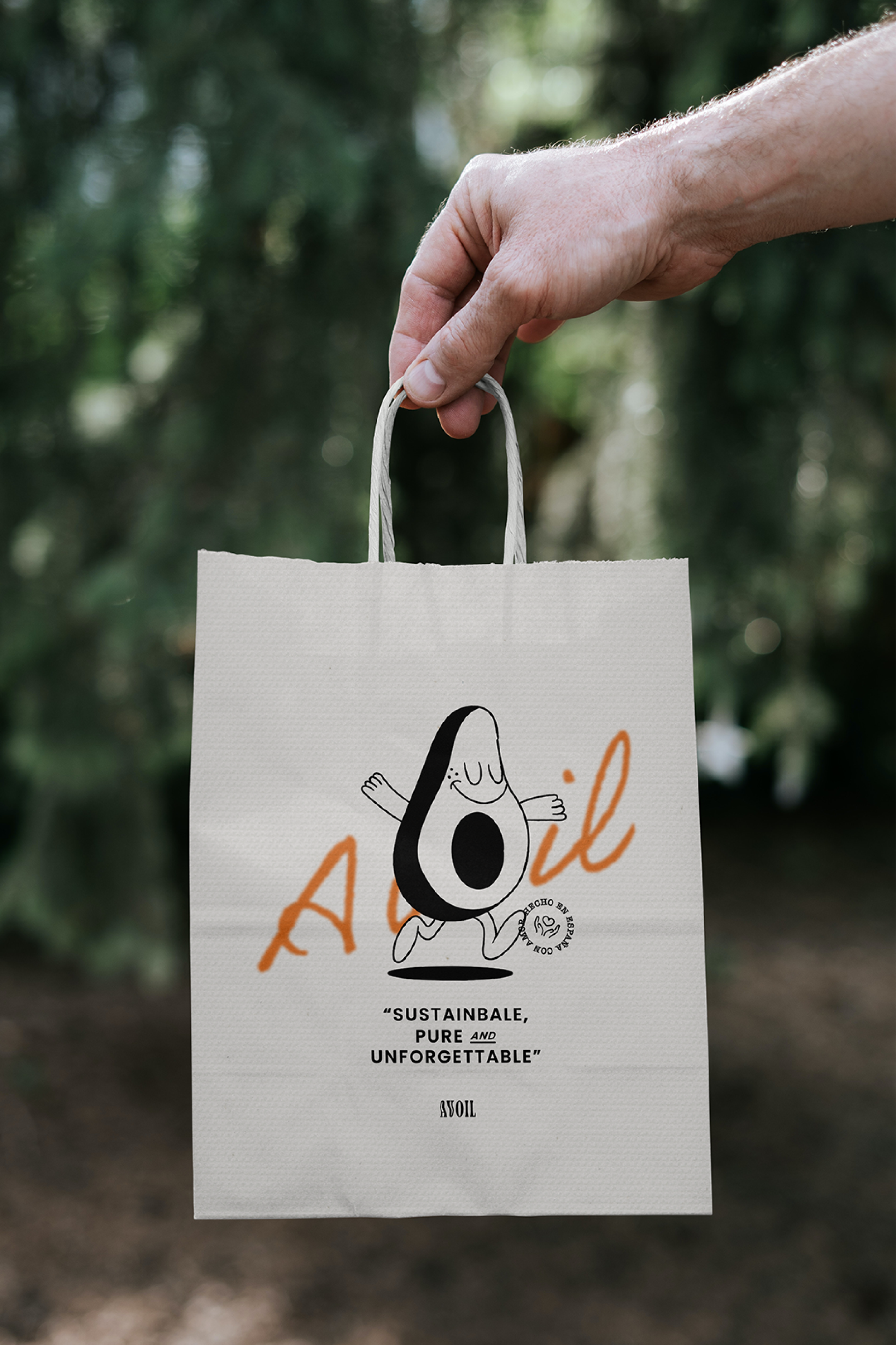 Person holding a paper bag with a cartoon avocado and text 'Sustainable, Pure and Unforgettable' and 'Asoil' logo on it.