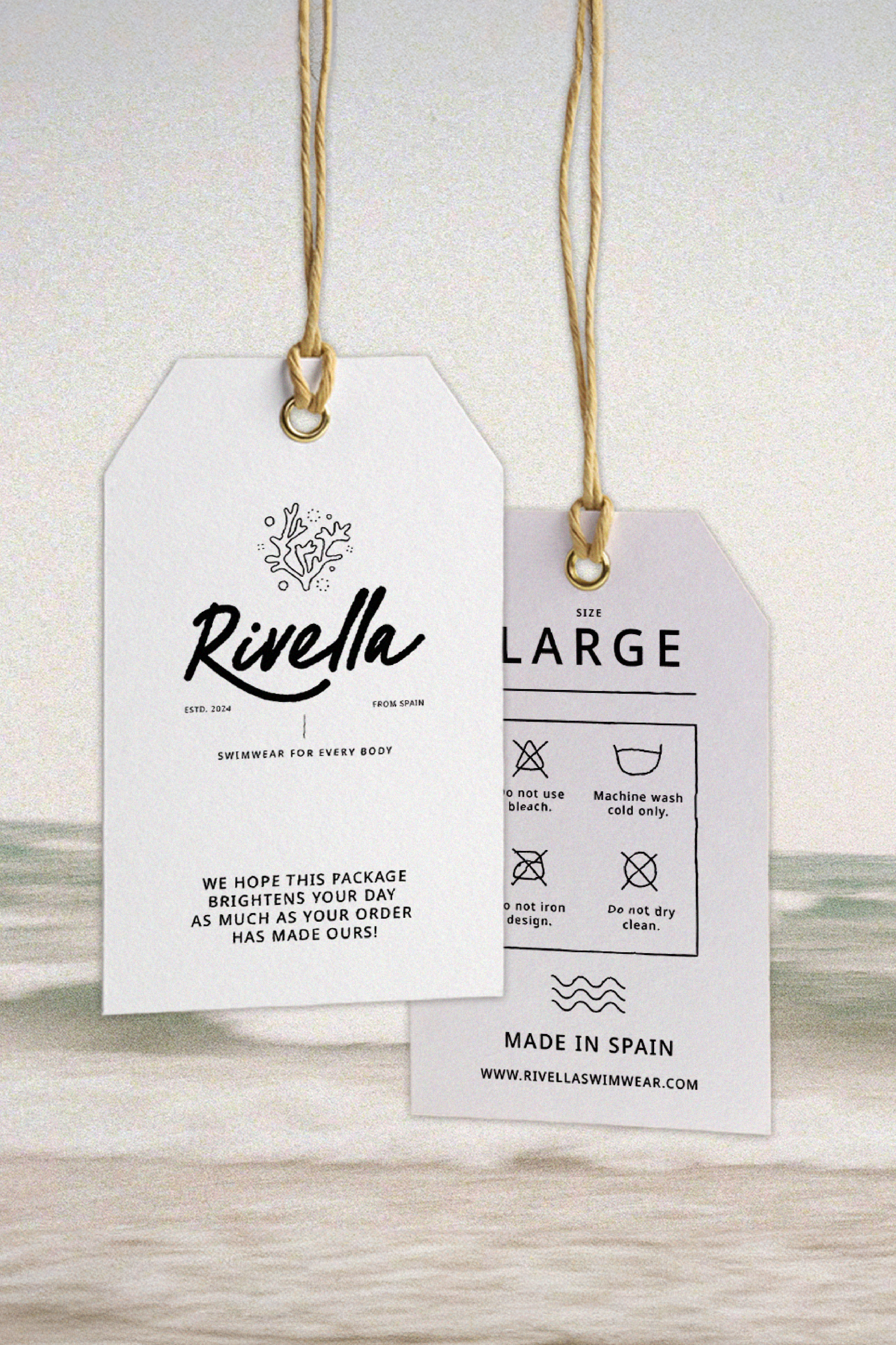 Two white clothing tags hanging on strings, displaying "Rivella" brand swimwear details, care instructions, and the tagline "Swimwear for Every Body". One tag notes "Made in Spain" and provides washing instructions. Background has a soft wave pattern.