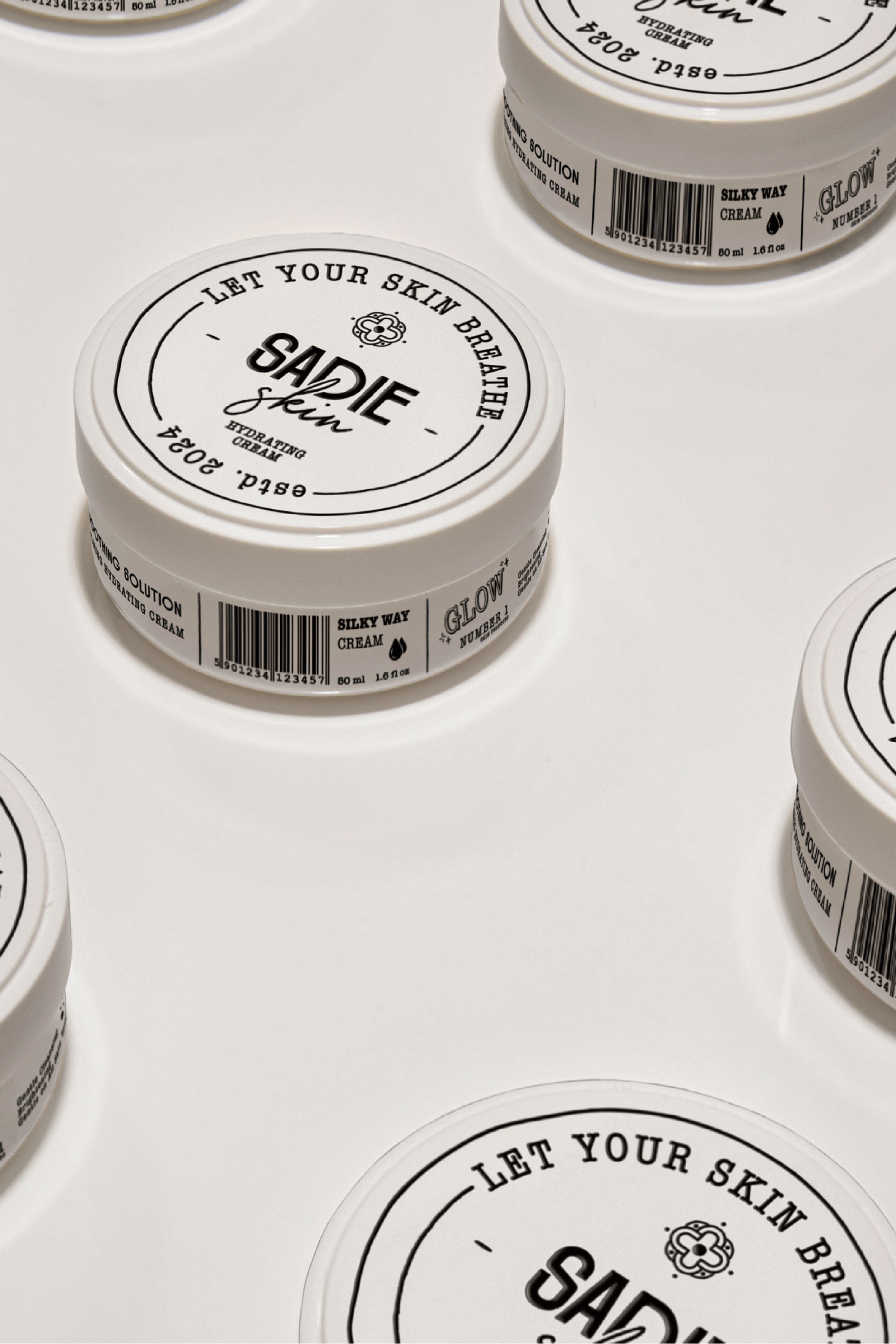 Multiple containers of "Sadie Skin" hydrating cream on a white background with product labels showing.
