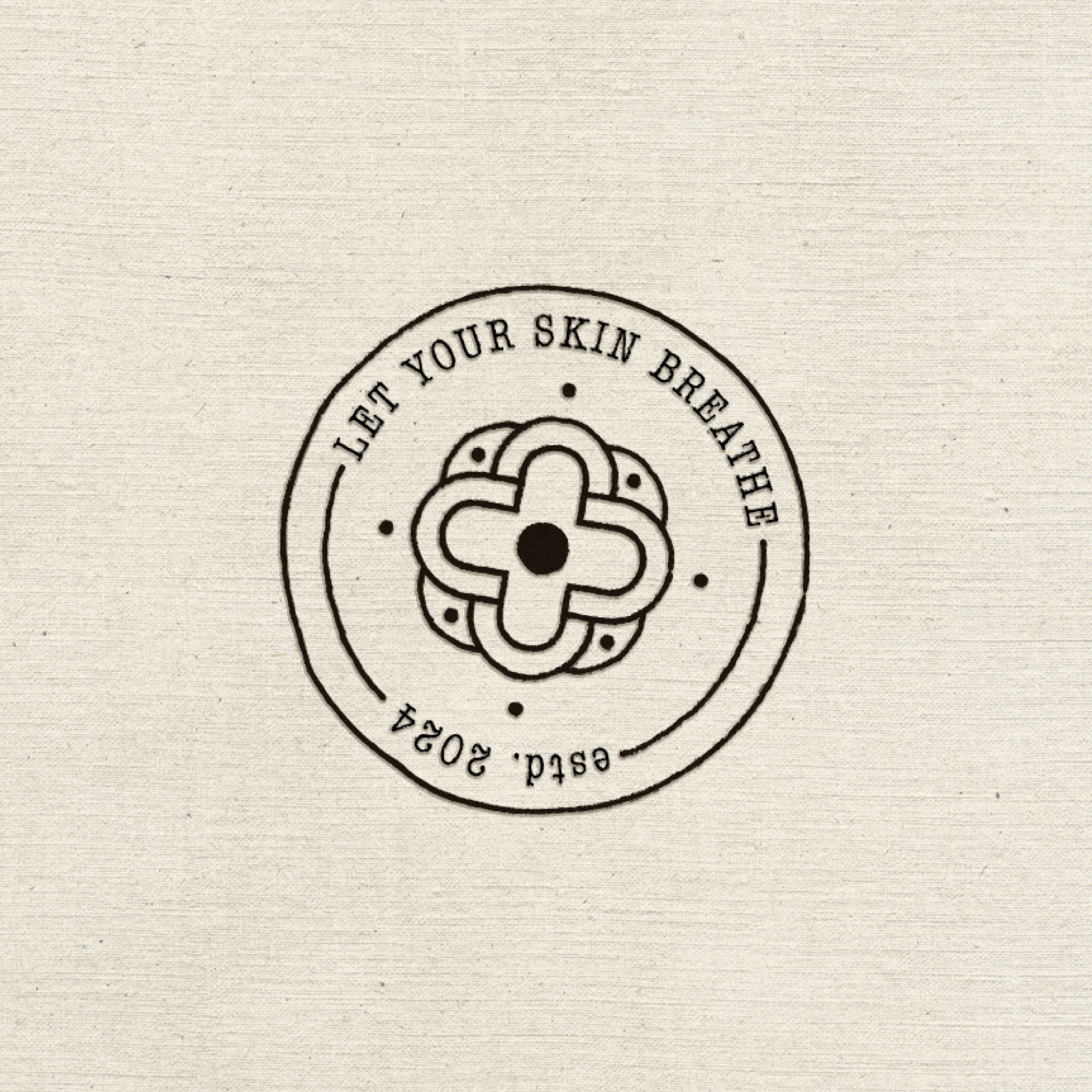 Circular logo with a central geometric design, surrounded by the text 'Let Your Skin Breathe' and 'Est'd. 2024' on a textured background.