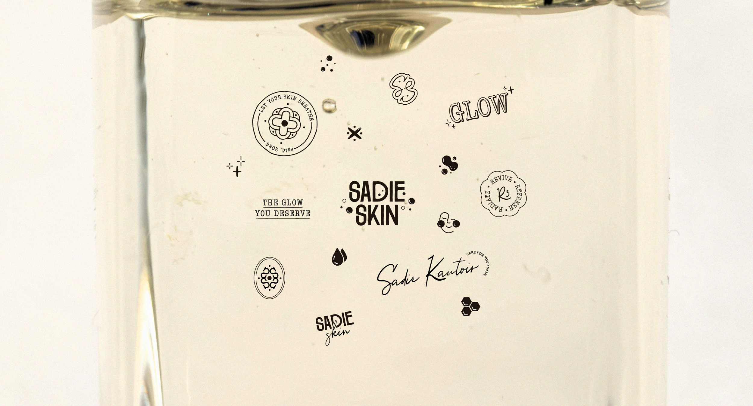 Glass jar with text and symbols including "Sadie Skin," "Glow," and skin care slogans.