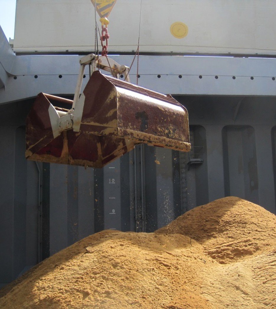 A grab hovering inside the hold of  ship.