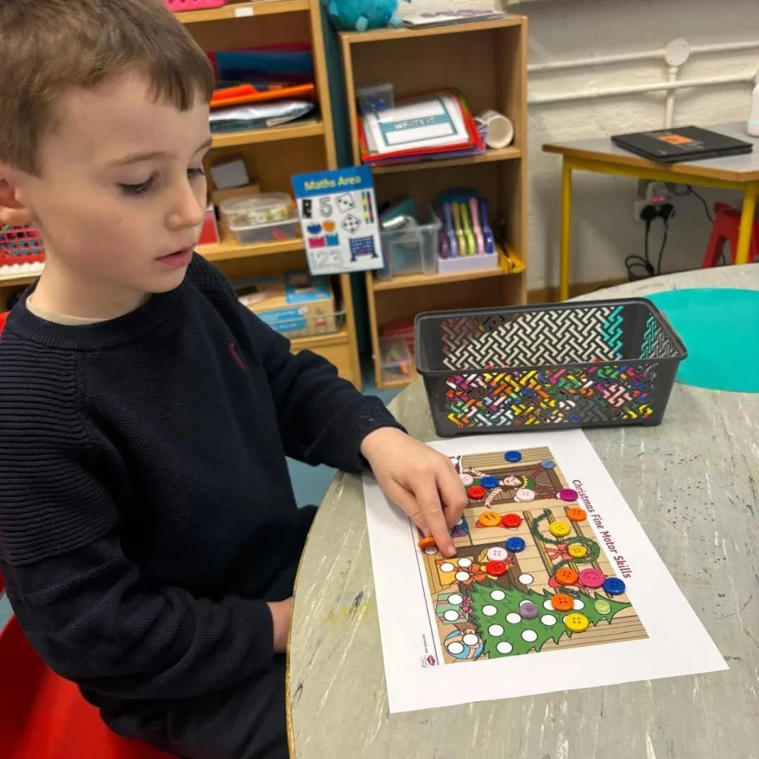 Senior Infants working on their fine motor skills witha Christmas twist