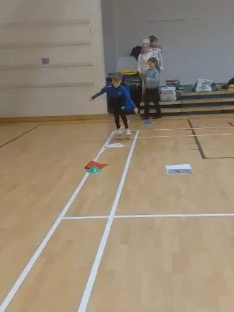 Grace's class practising jumping skills for P.E