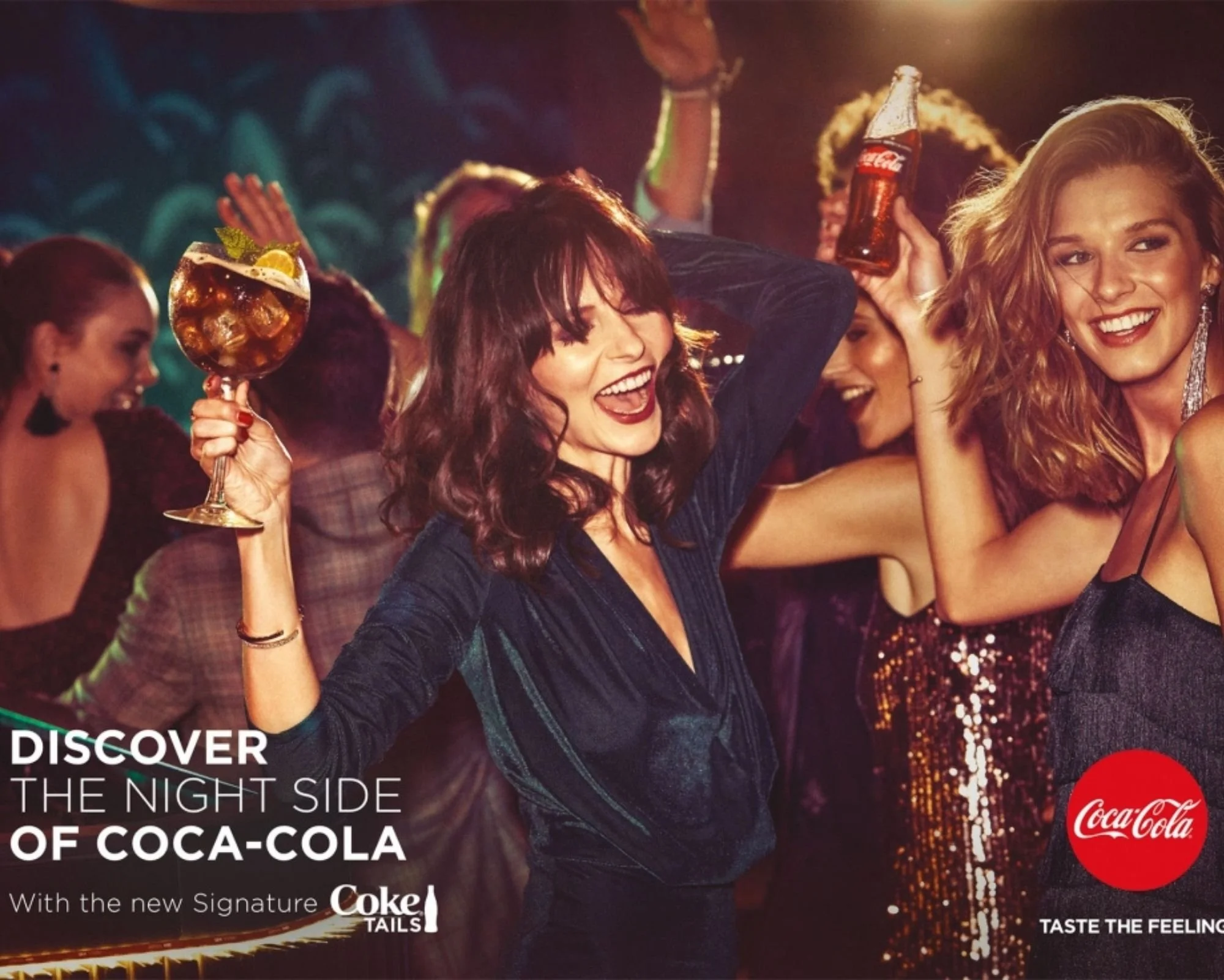 Group of people celebrating at a party with drinks, smiling and dancing in a lively setting with colorful lighting, Coca-Cola logo visible in the corner.