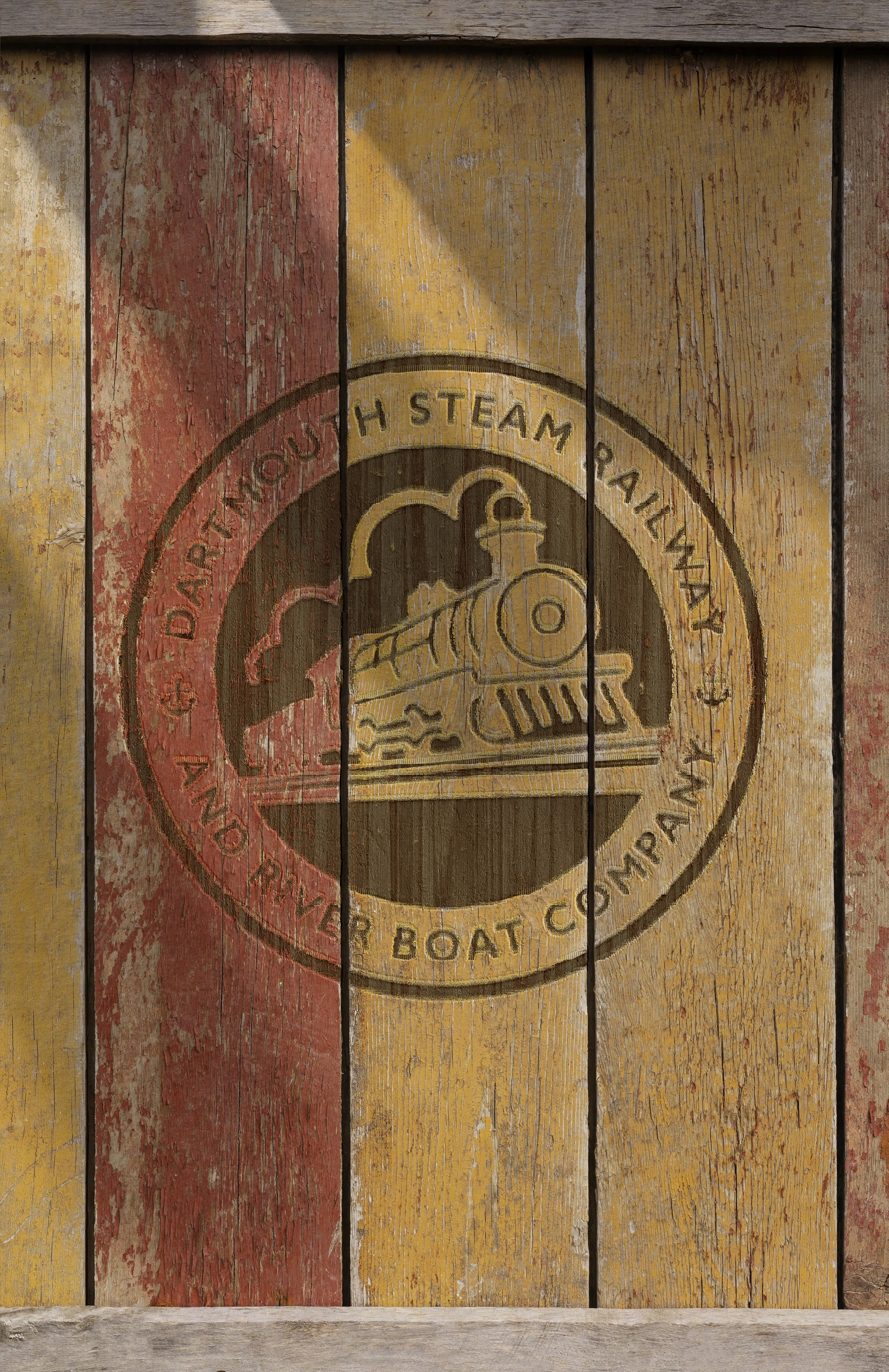 Painted wooden sign with a vintage steam locomotive and the words 'Darrington Steam Railroad And River Boat Company'.
