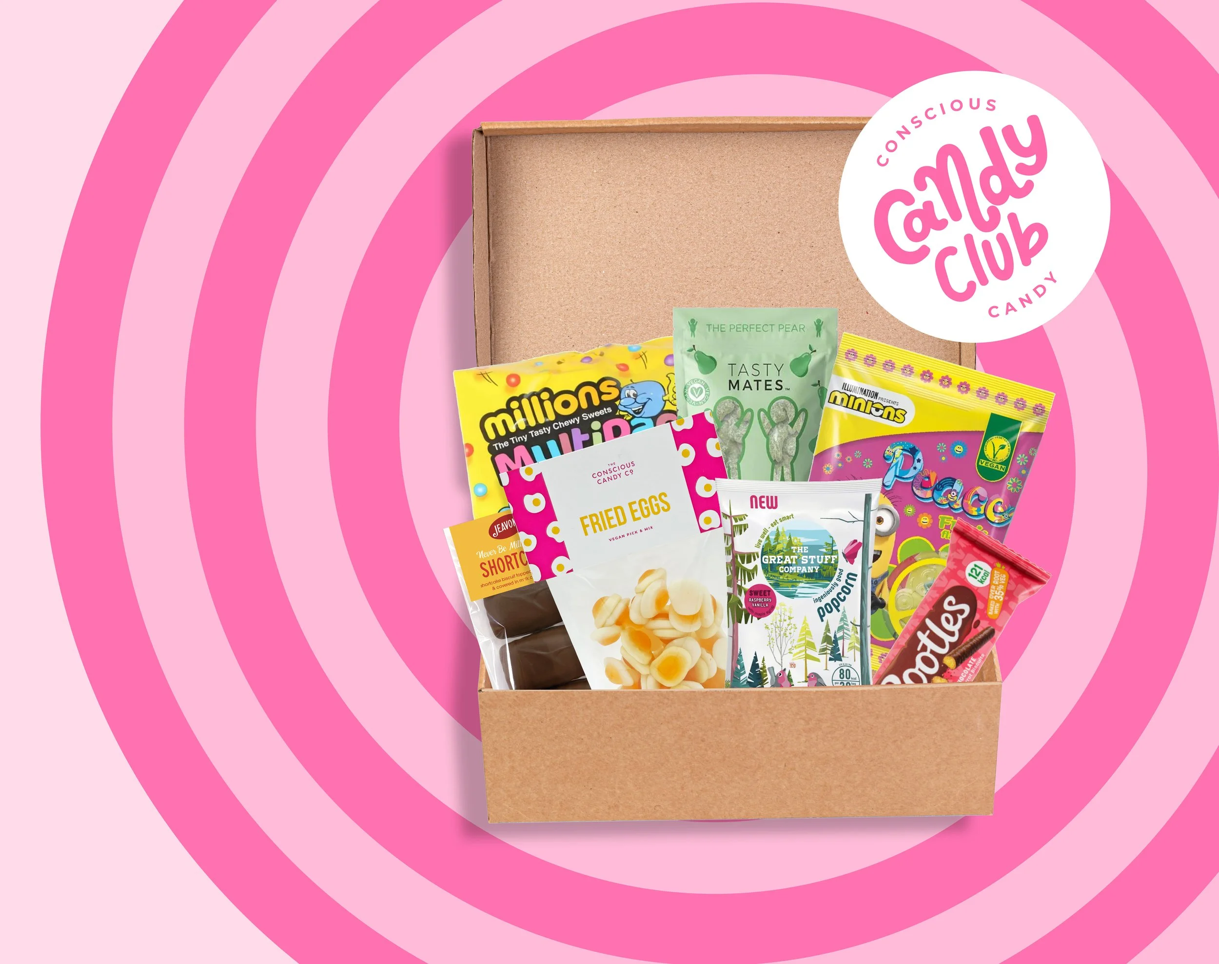 Open pink and brown Candy Club themed snack box containing various colorful candies and snacks, with a pink spiral background and a white logo circle reading "Conscious Candy Club."