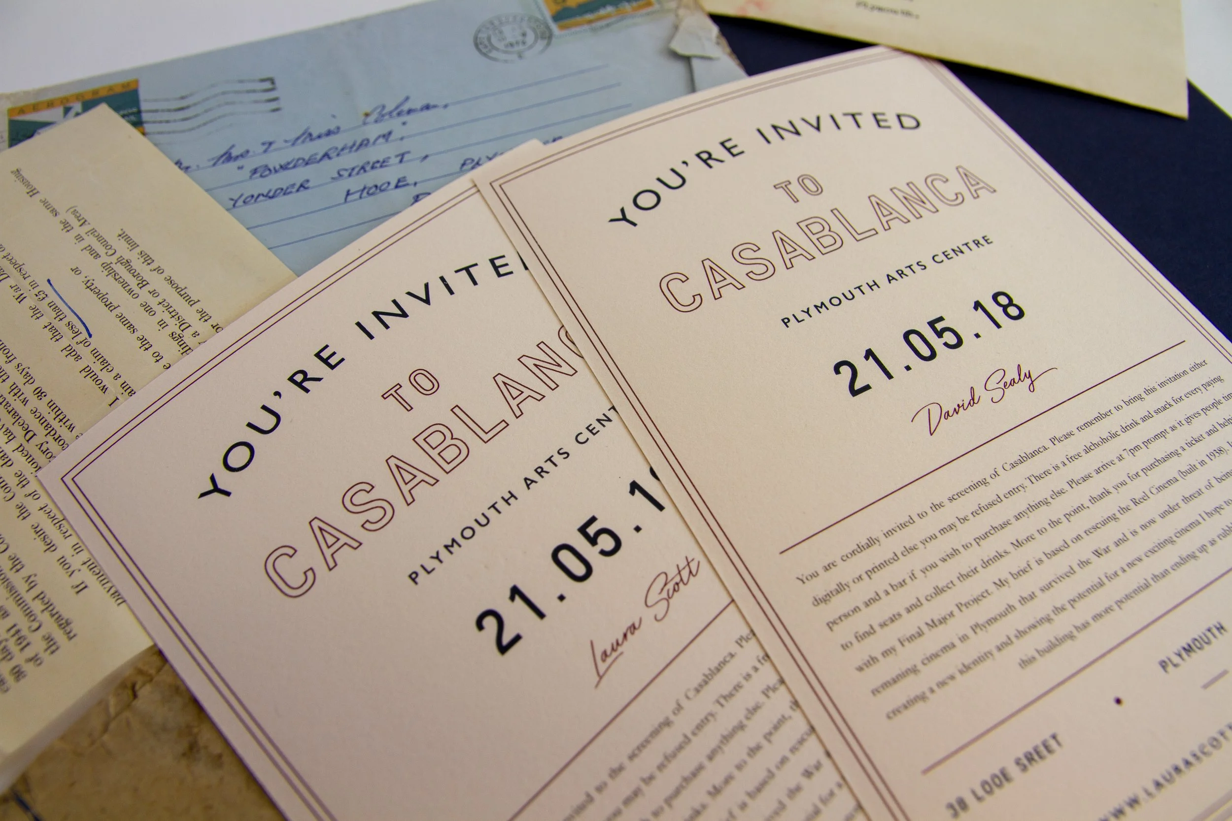 Invitation to a Casablanca event at Plymouth Arts Centre on May 21, 2018, signed by David Sealy, and an overlapping second invitation signed by Laura Scott, along with various papers and letters.