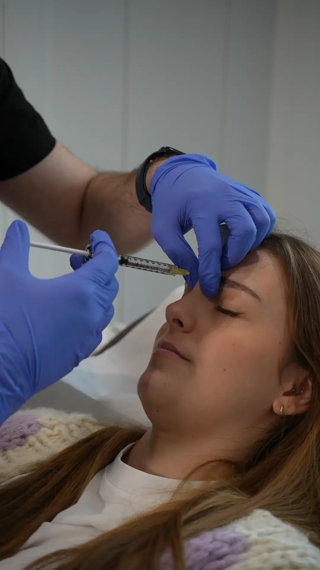 Dr Karim injecting Botox into forehead of patient