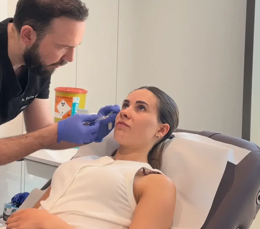Dr Karim treating a patients dark under eye circles with Dermal Filler